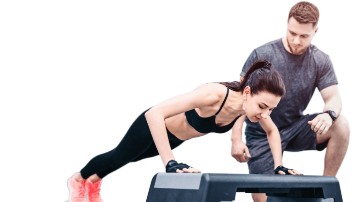 Woman doing push-ups with a trainer counting reps.