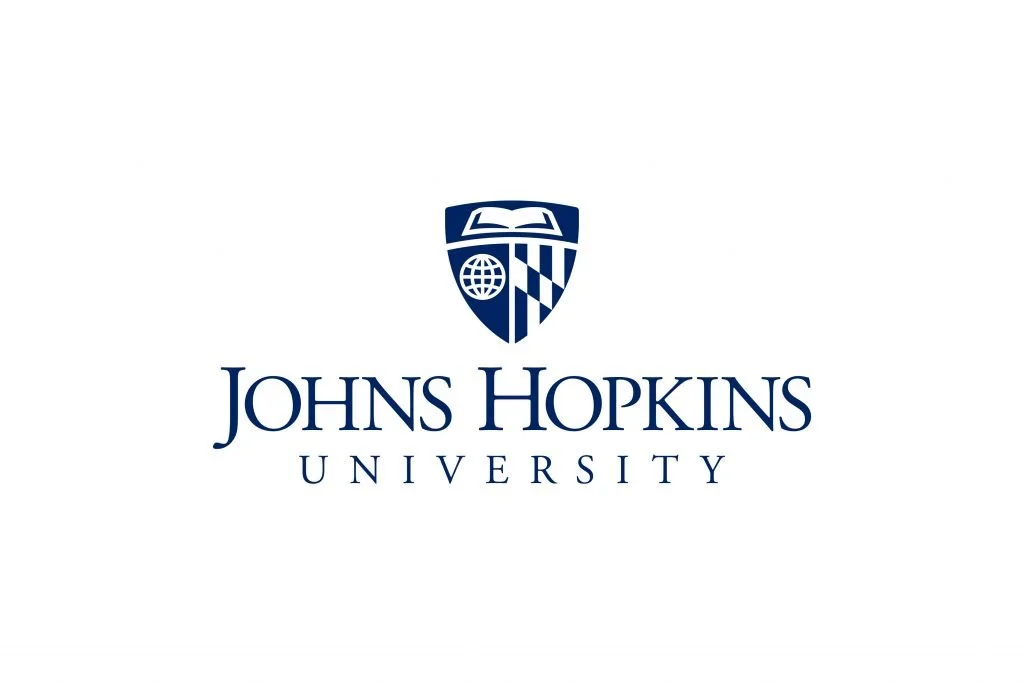 Logo of Johns Hopkins University featuring a shield with a globe and book, and the university name beneath.