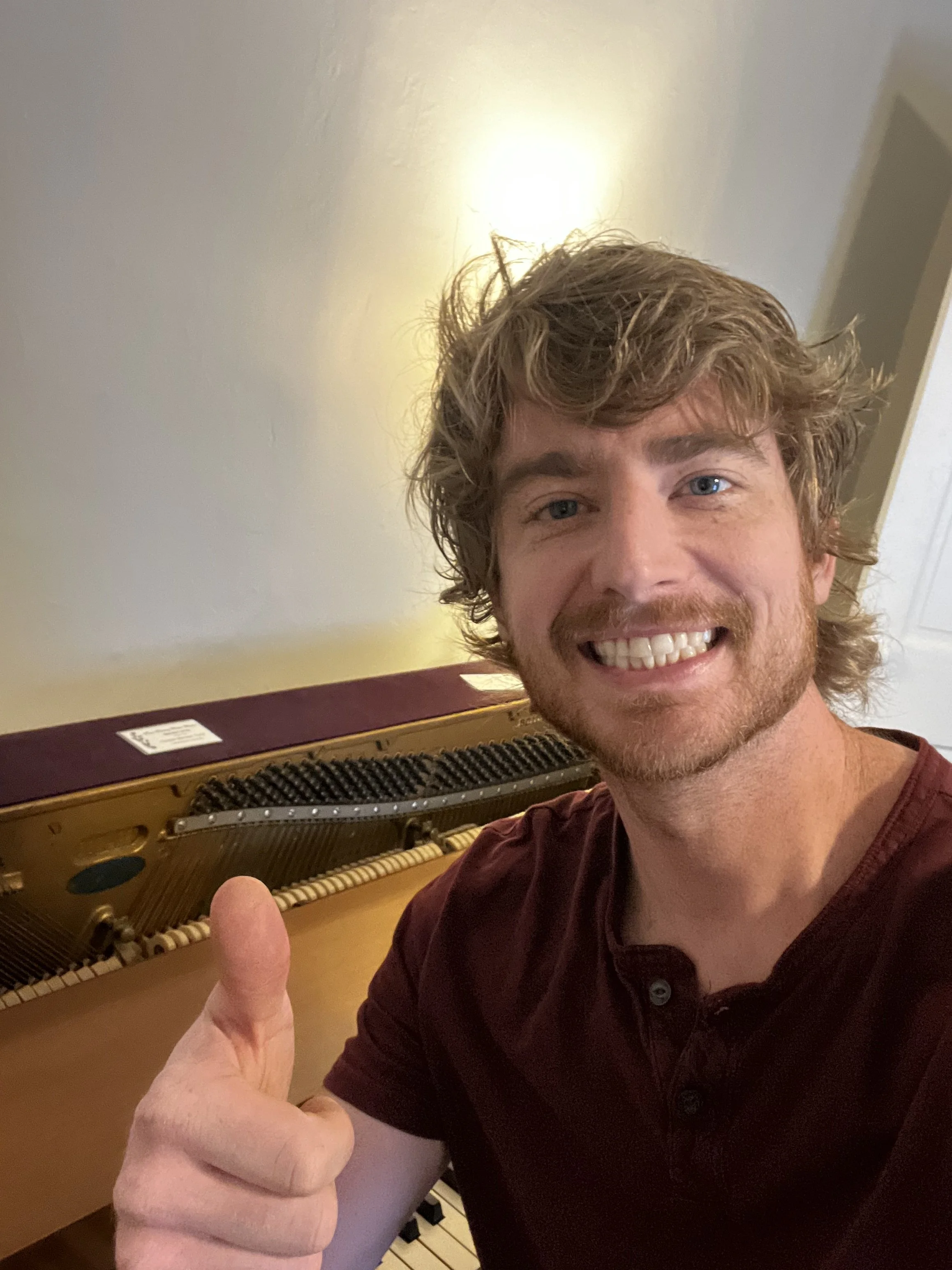 Piano Tuner Sitting Behind Piano in Southwest, VA