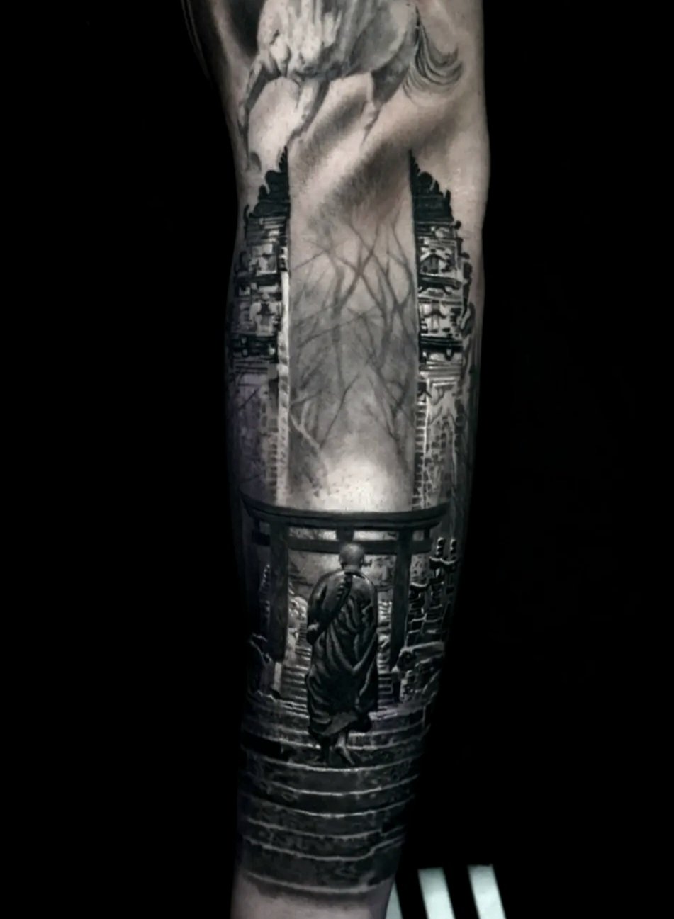 Black and gray tattoo of a Buddhist monk walking through a torii gate, with a cityscape and abstract elements in the background.