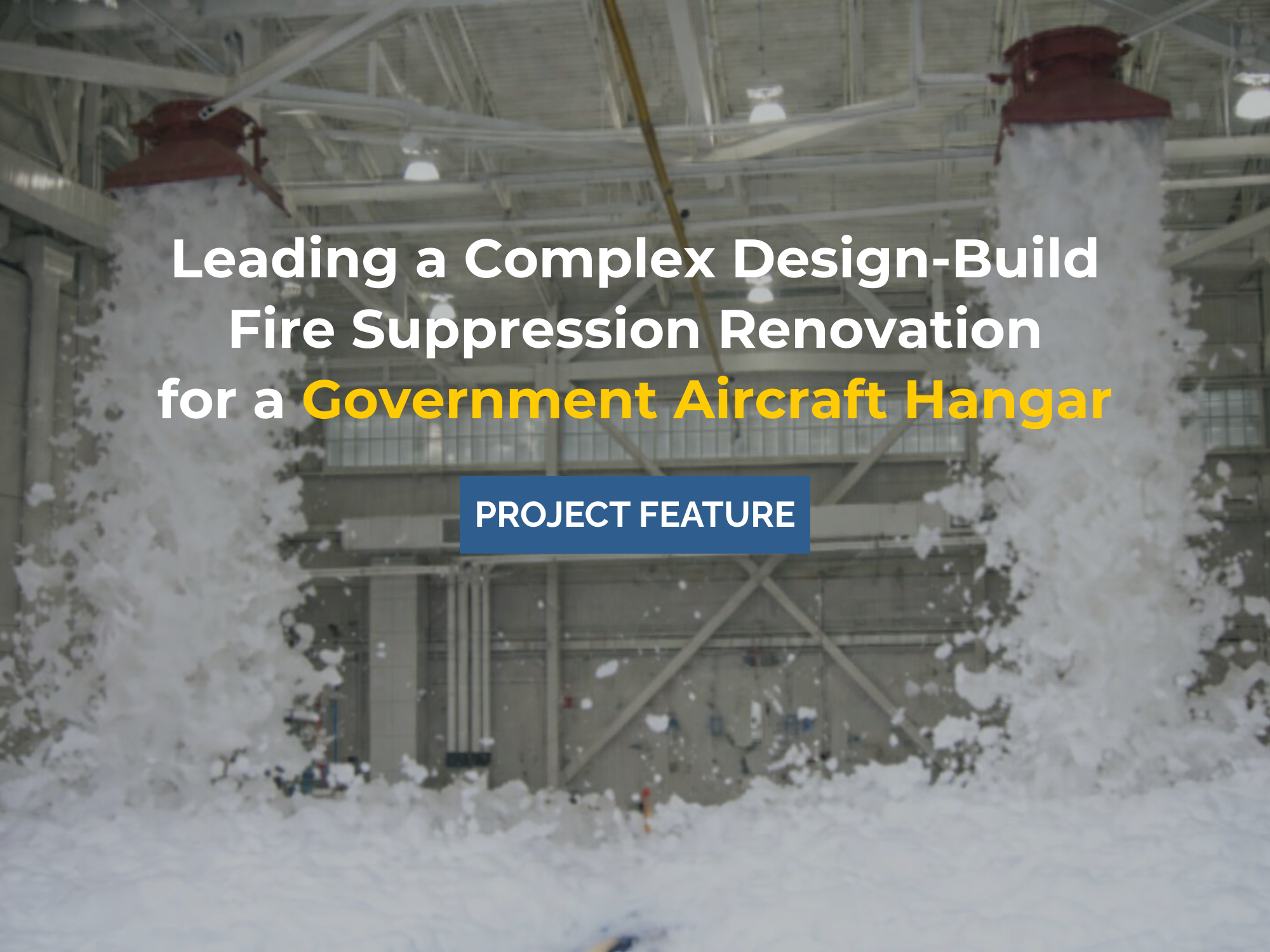 Foam fire suppression system discharge testing inside government aircraft hangar during design-build renovation.