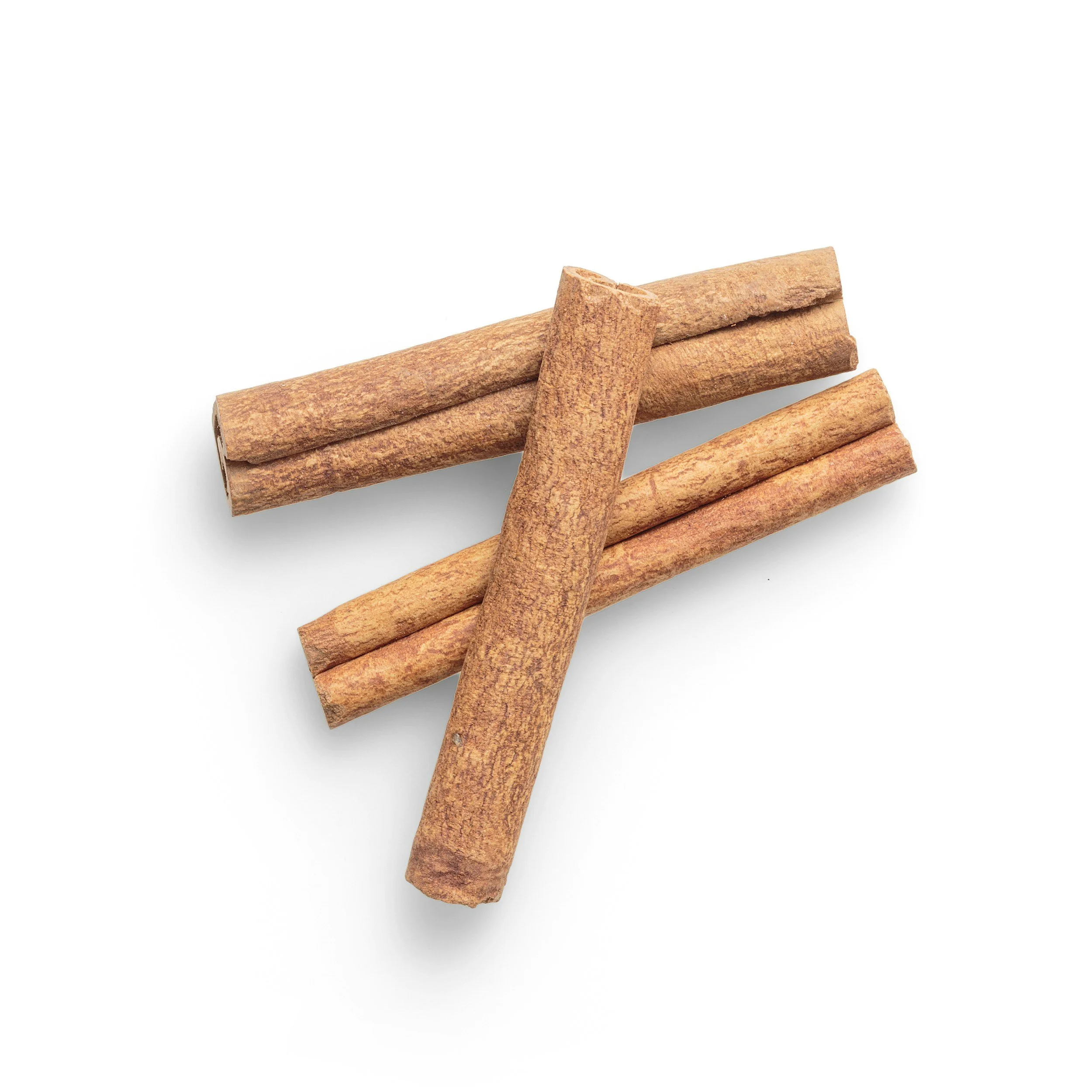 Four cinnamon sticks on a white background.