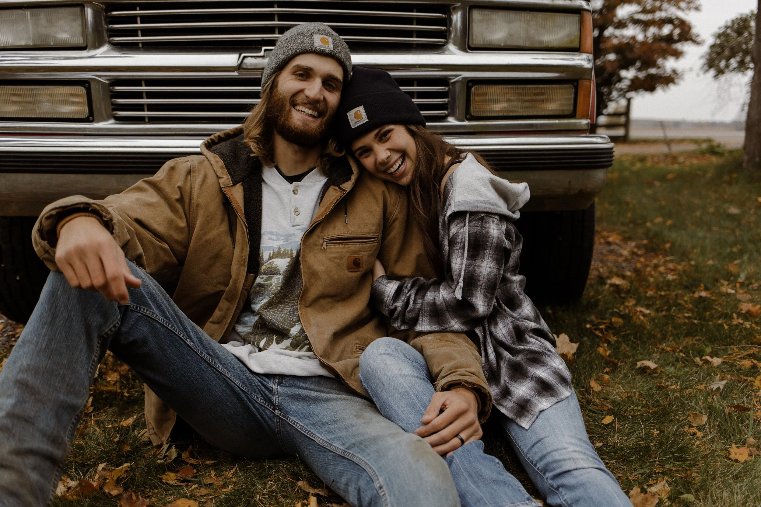 A family that loves living on a homestead and making handcrafted organic skincare and natural products as well as holistic remedies for others. They are leaning against a truck wearing beanies.