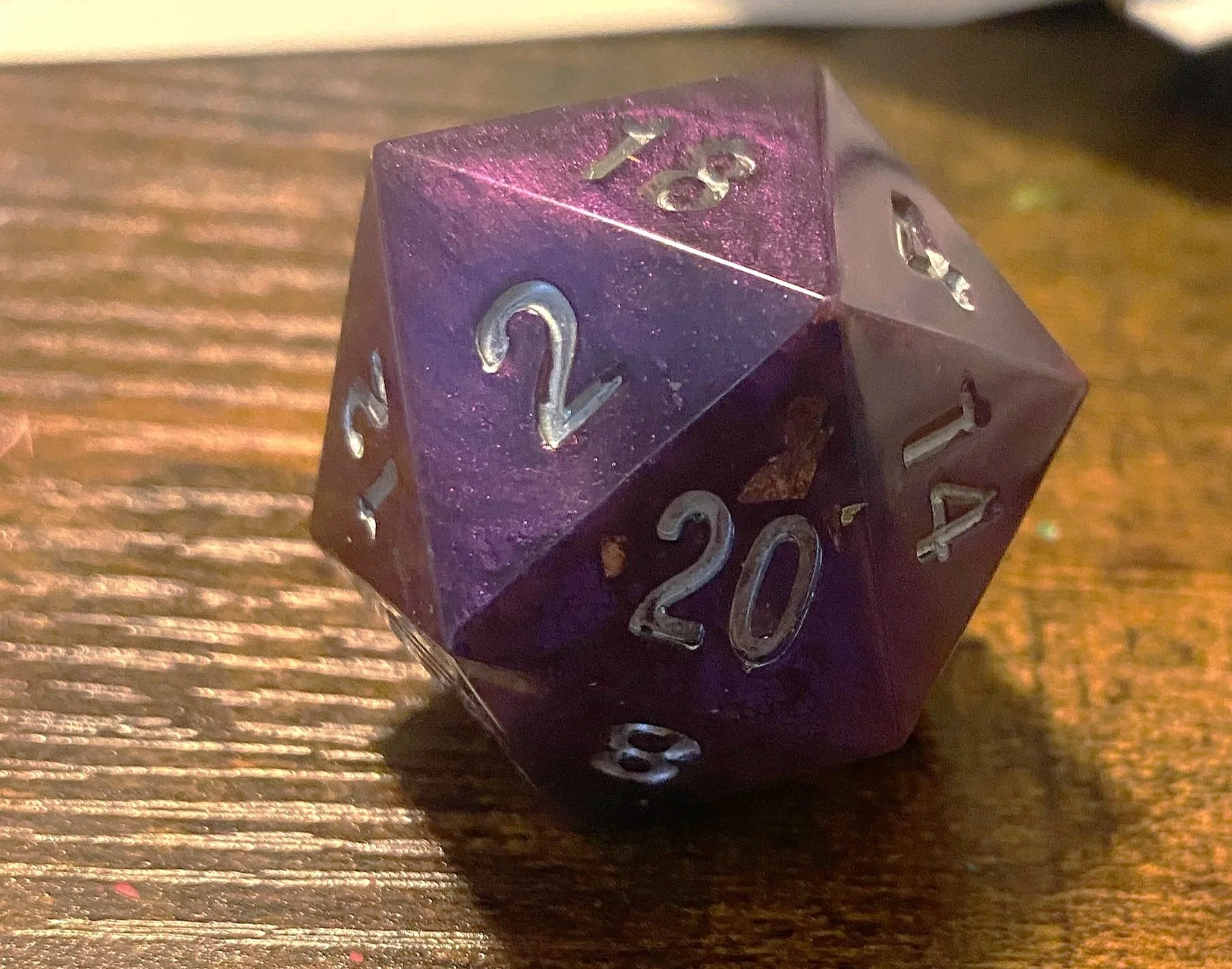 At the end of our first big campaign, I made a set of dice for each of the players that contained a die that referenced all of our characters. This was for a character whose magic and themes kept coming back to the color purple. This set was opaque w