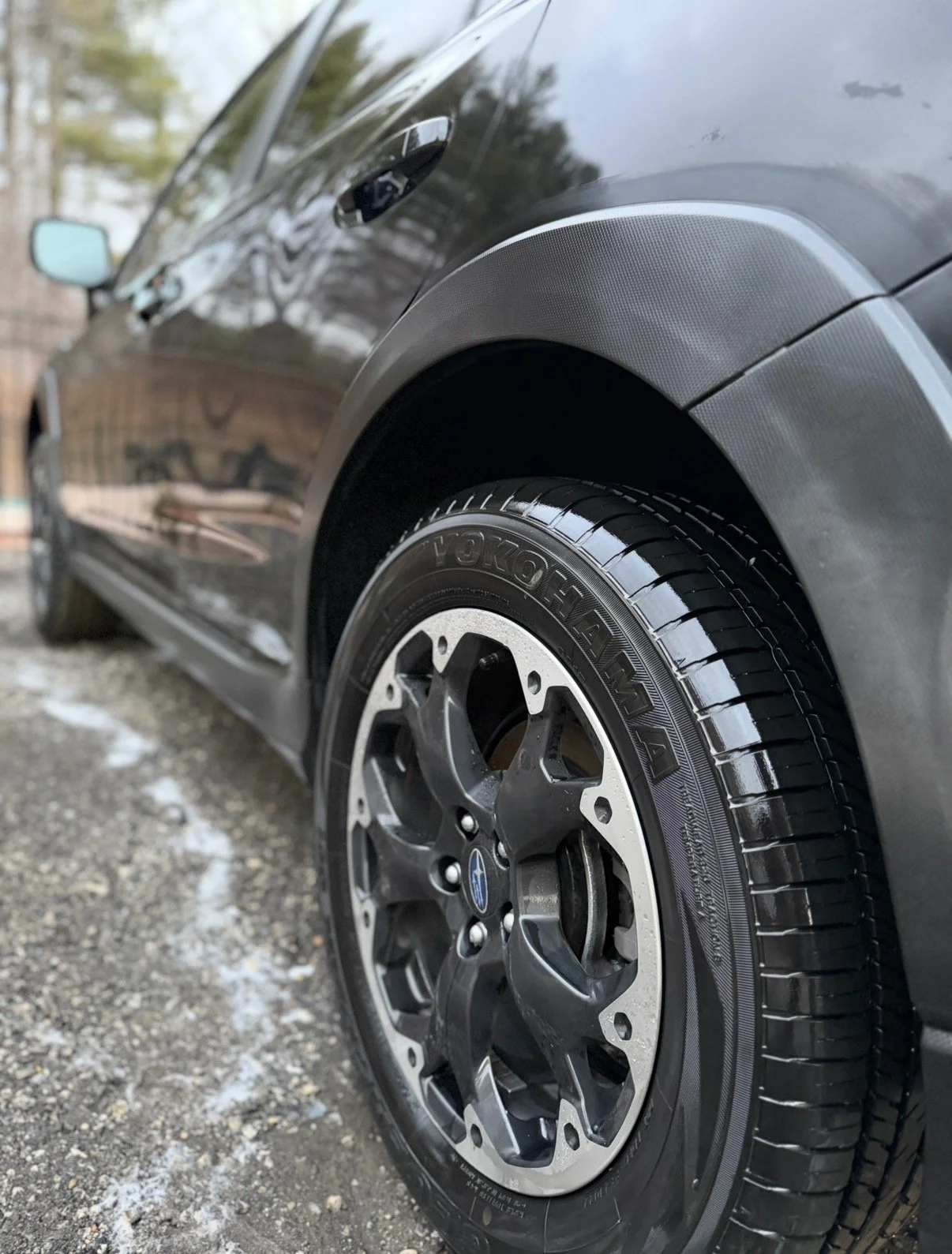 Black wheels and dark grey trim of a black subaru crosstrek that has been detailed