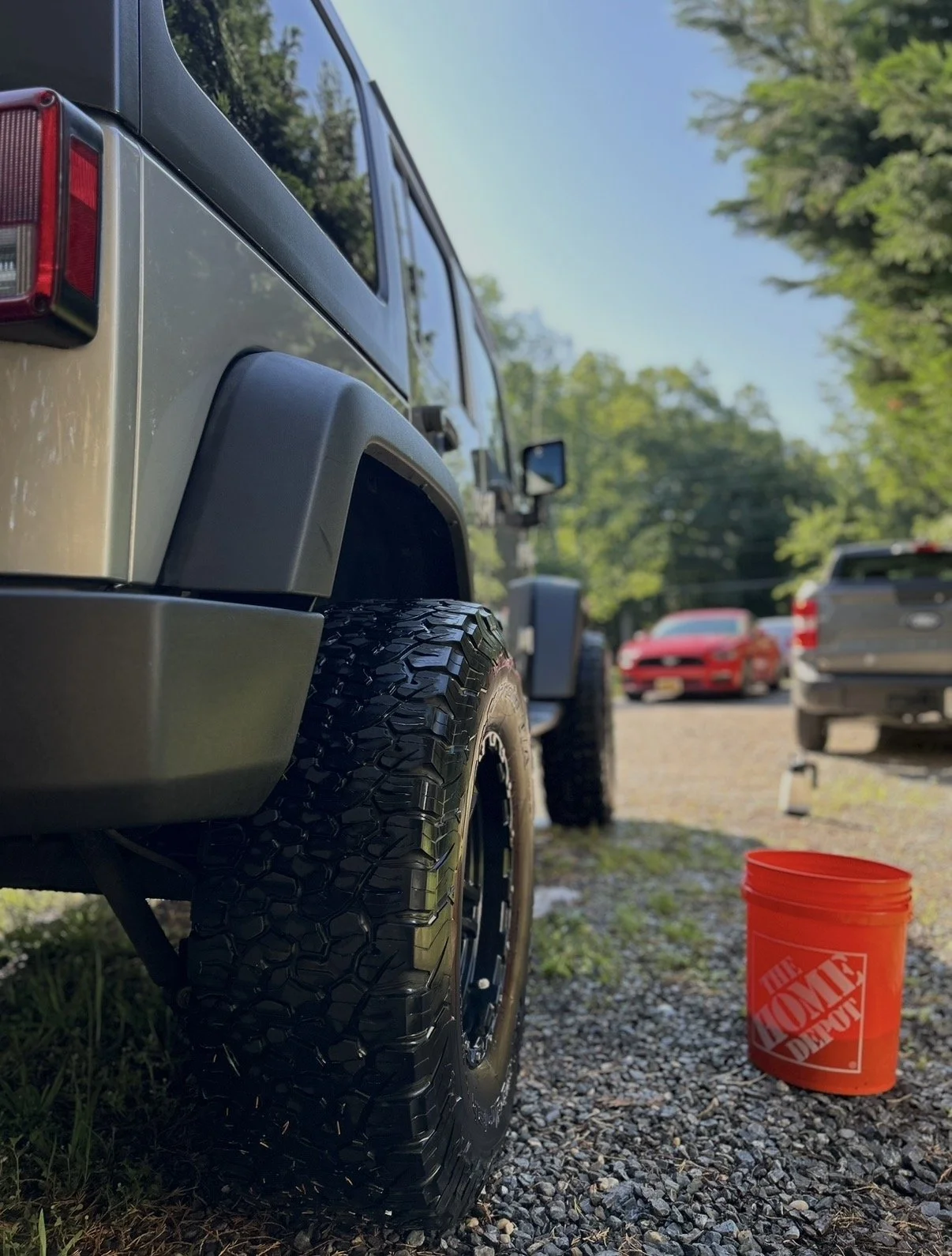 Silver Jeep clean with a home depot bucket