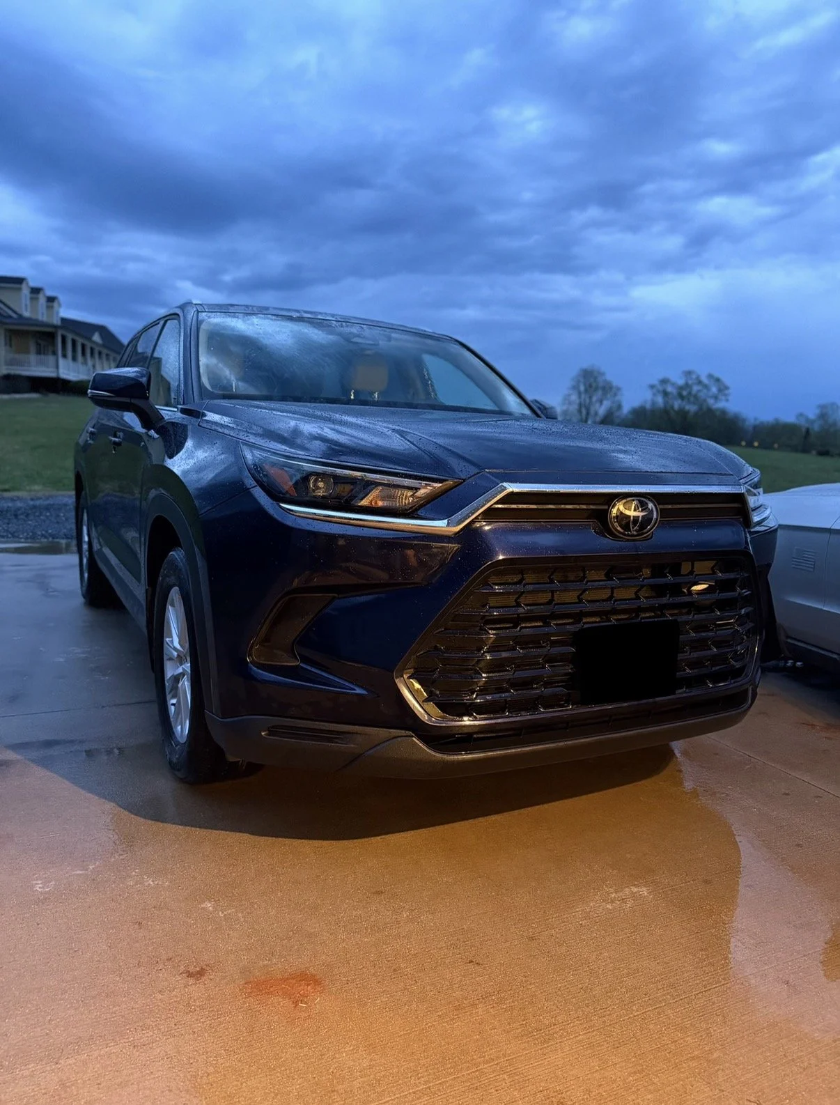 A navy blue toyota grand highlander freshyl washed after a storm