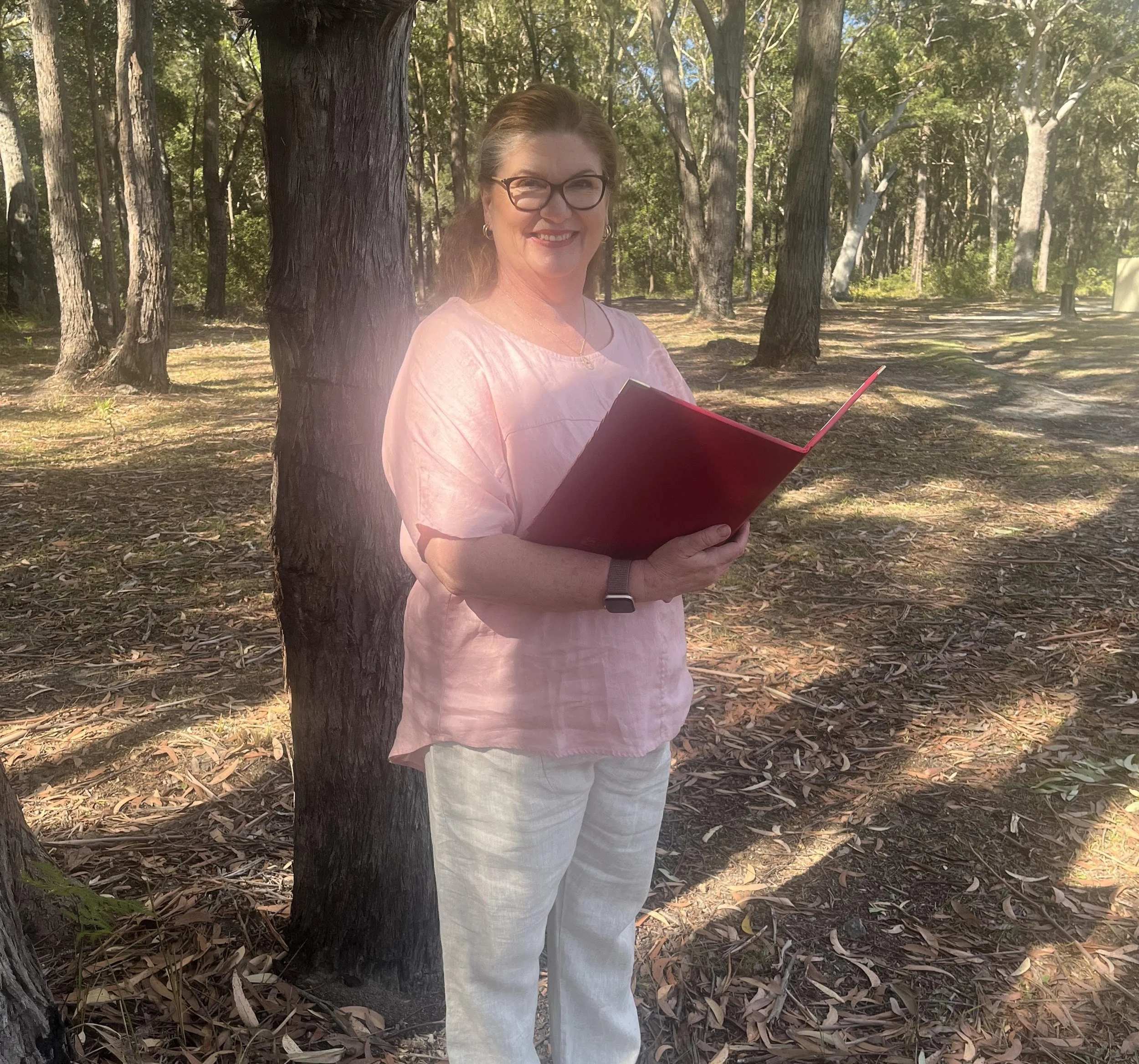 Sharon the celebrant marrying a couple under a tree