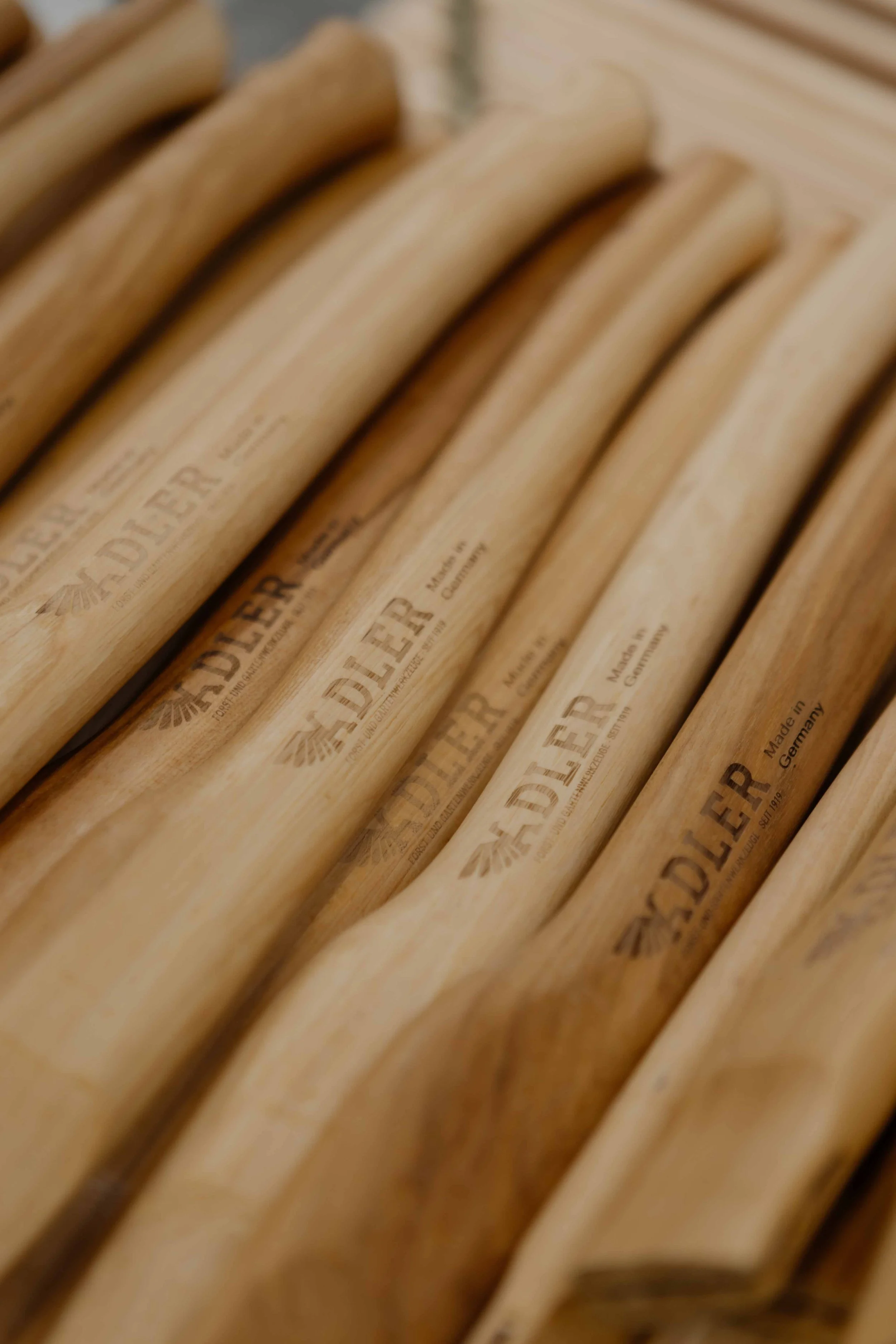 Close-up view of several wooden shoehorns with the brand name 'EDLER' and 'Made in Germany' engraved on them.