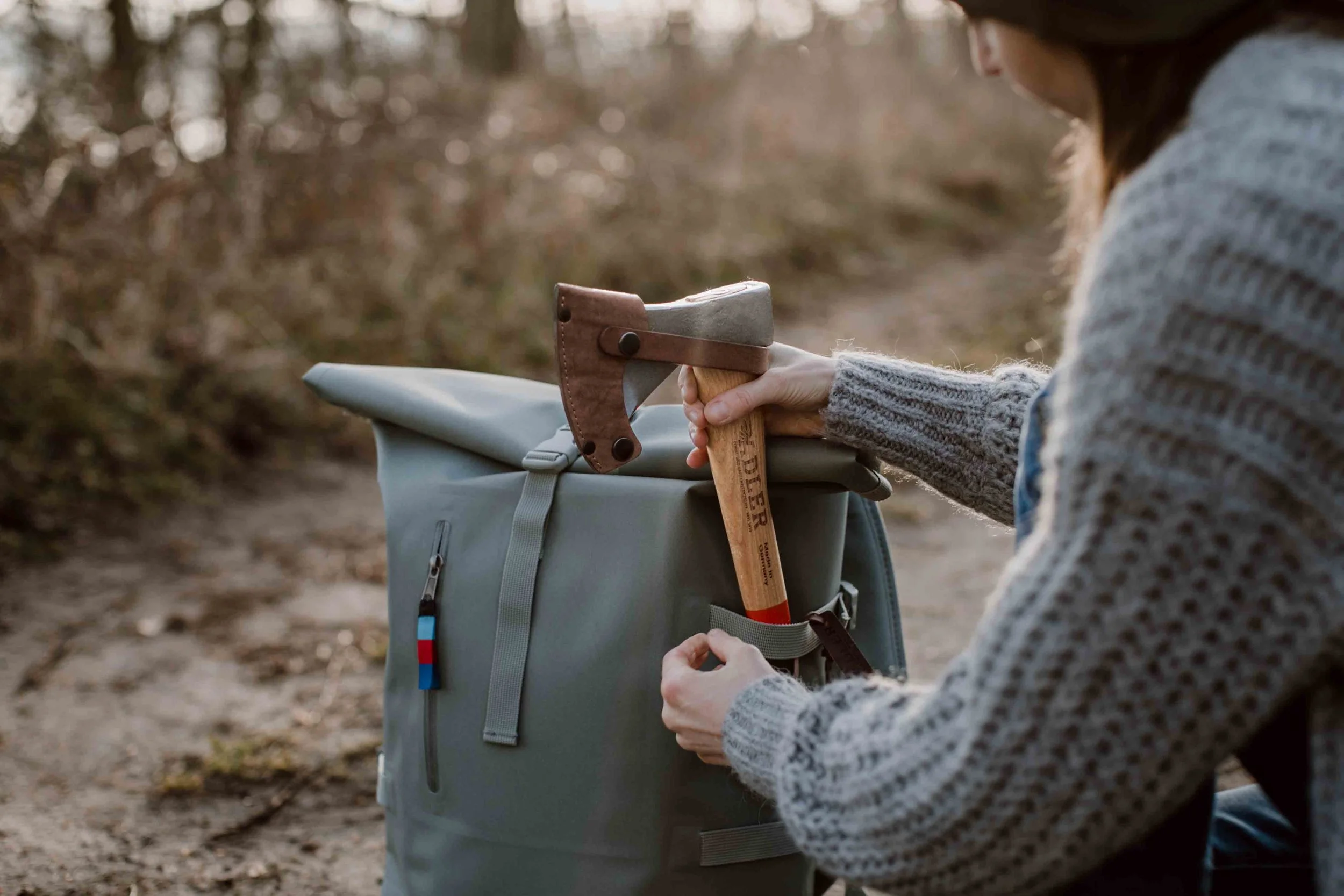 Wooden axe storage rack displaying multiple Helko axes organized for easy access and safety