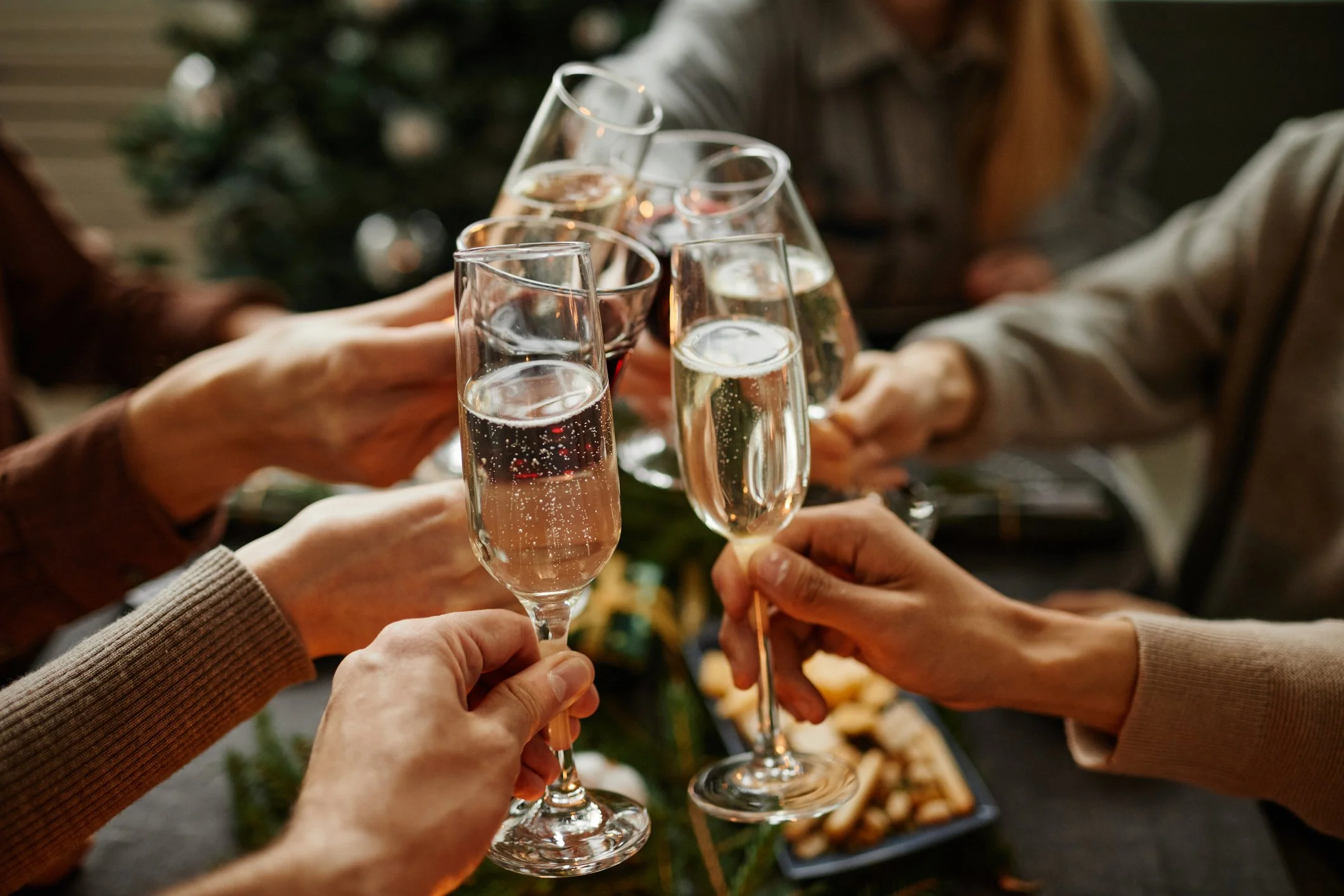 People holding champagne glasses in a toast during a celebration.