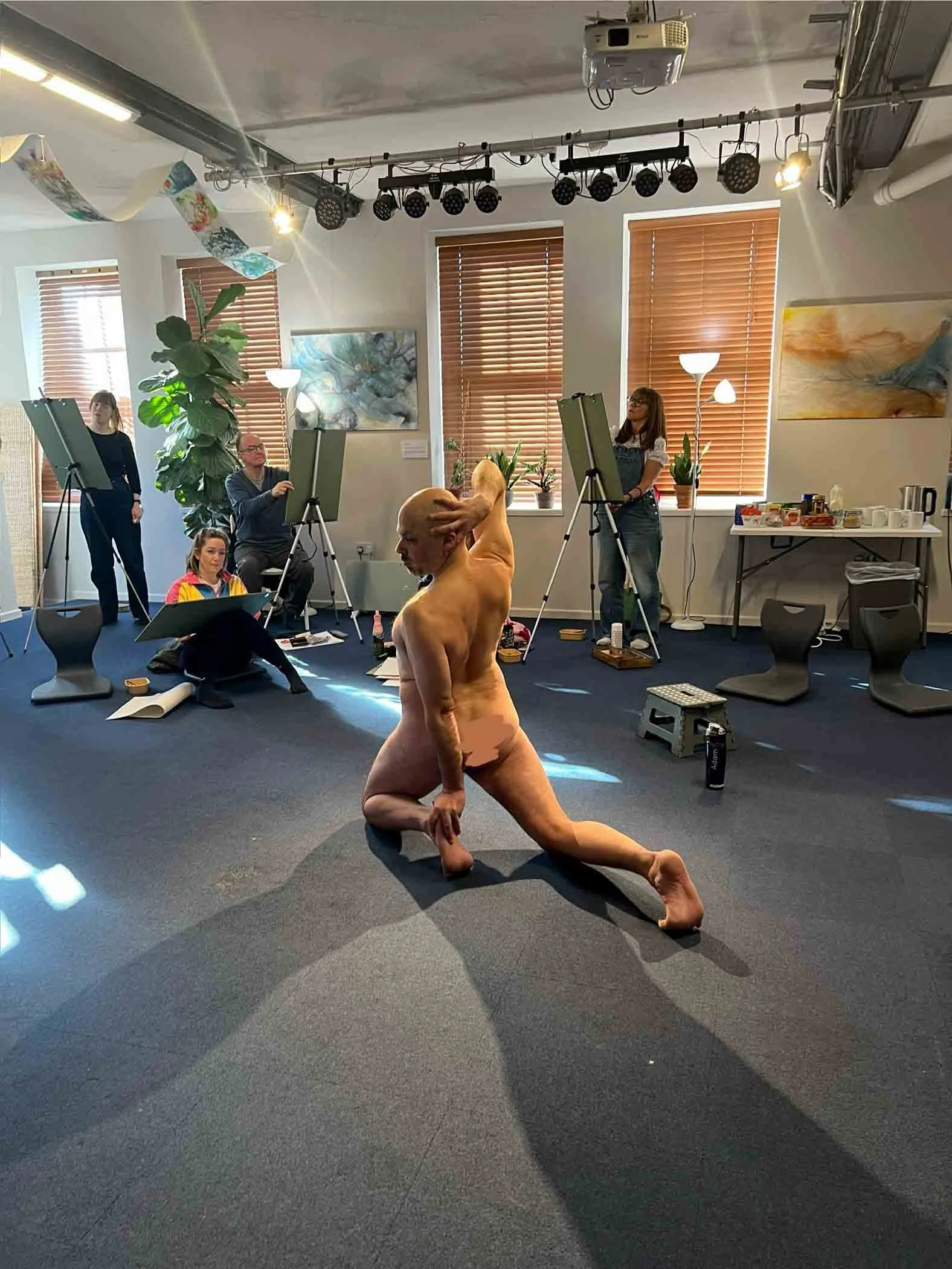 Life Model being drawn by Now, Draw! participants. Easels.