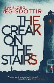 Book cover for 'The Freak on the Stairs' by Eva Bjórg, Egisdoottir, featuring a lighthouse at night with a red light, dark sky, and a small silhouette of a person at the bottom.