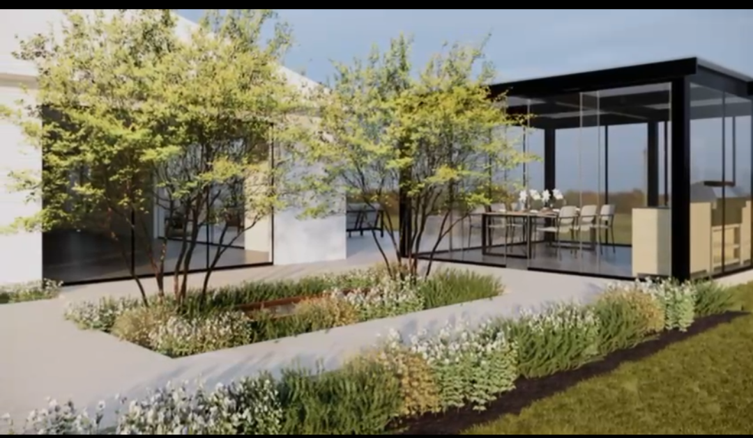 Modern house with large floor-to-ceiling windows, surrounded by trees and landscaped garden with flowering plants and grass.