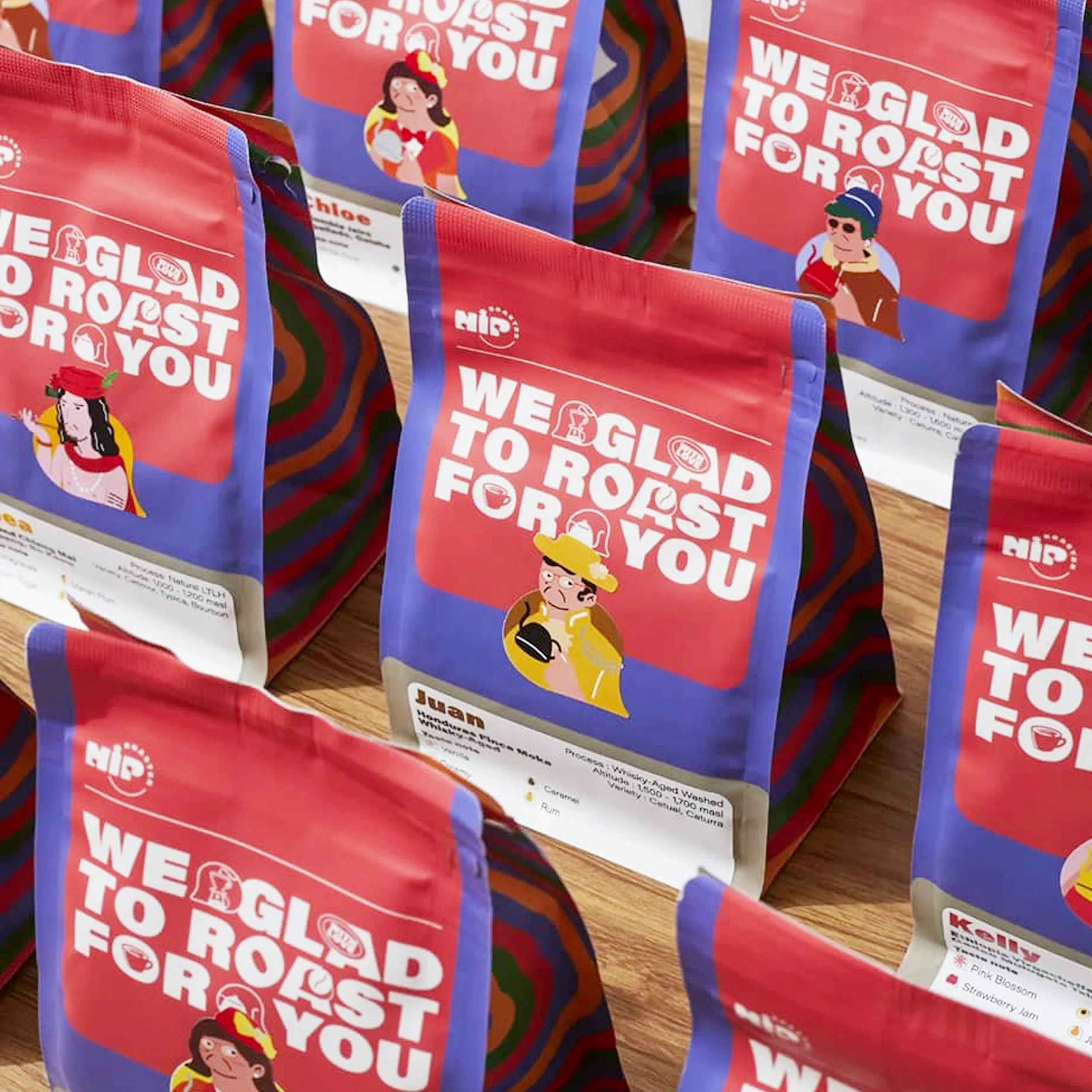 Multiple bags of coffee with colorful packaging, featuring illustrations of characters in costume and the slogan 'We Glad to Roast for You'.