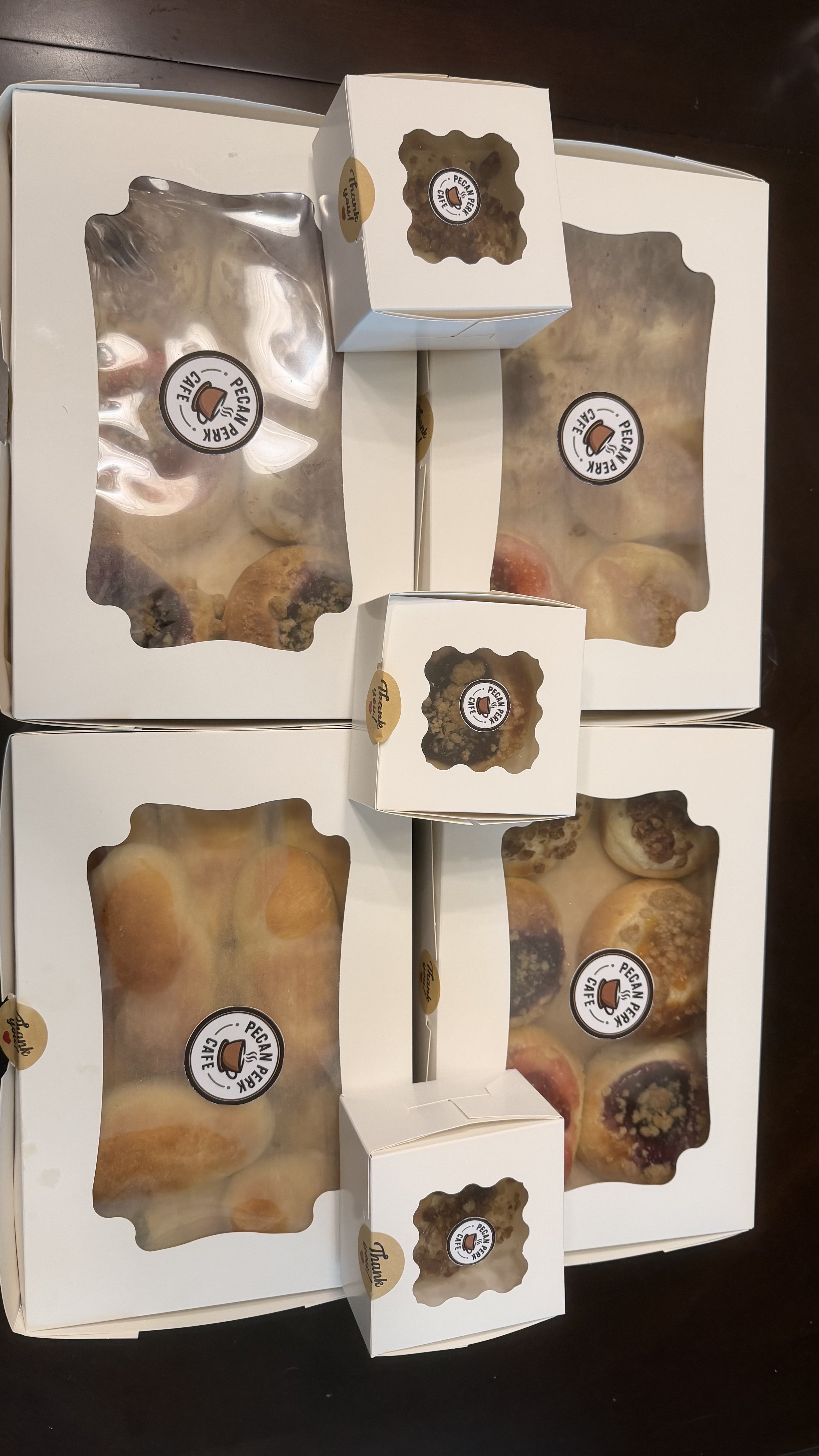 Boxes of assorted cookies with transparent windows, labeled 'Pecan Pie Caffe'.