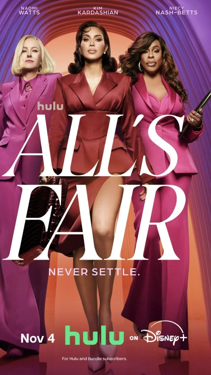 Promotional poster for the TV series 'Ugly Betty' featuring Naomi Watts, Kim Kardashian, and Niecy Nash-Betts dressed in pink and red suits, with the title 'All's Fair' in large white text, and the tagline 'Never Settle.' It announces the show's premiere on Hulu and Disney+ on November 4.