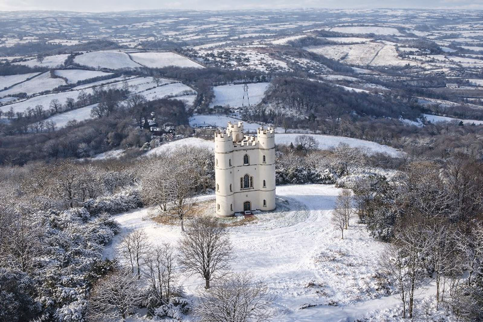 Snowy castle atop a winter hill.png