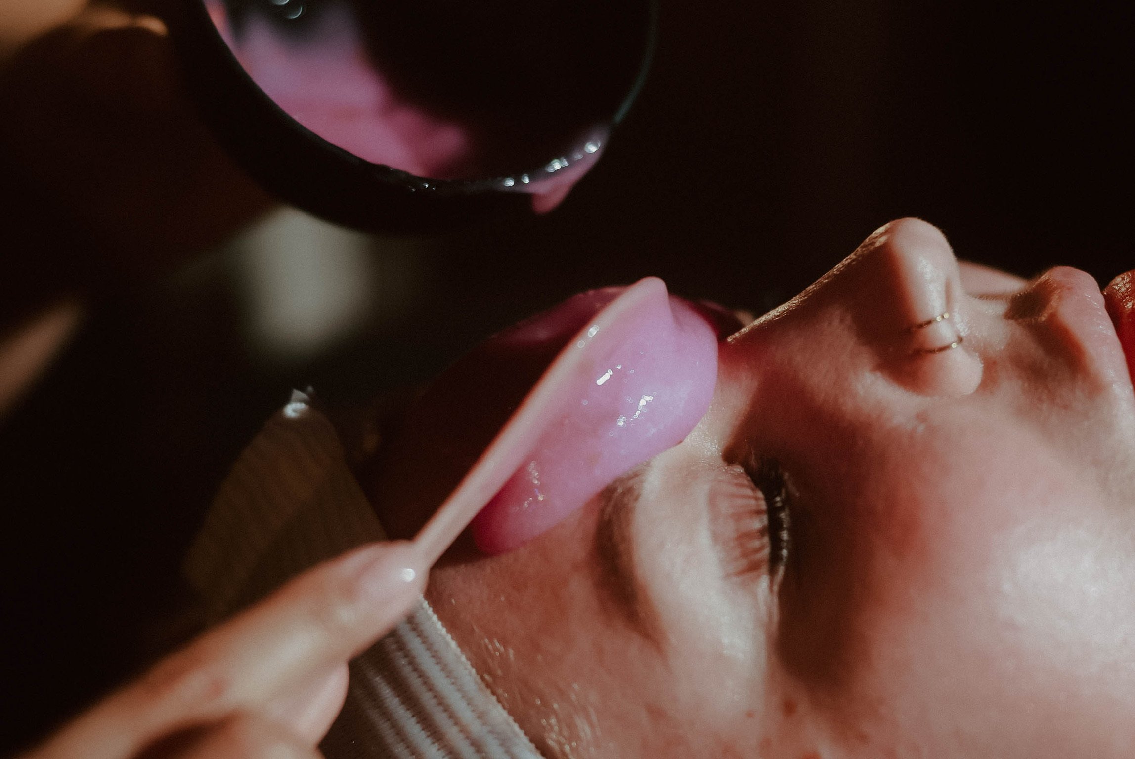 Close-up of a Maven Haus patient having a professional skincare treatment applies with a small spatula by a provider.