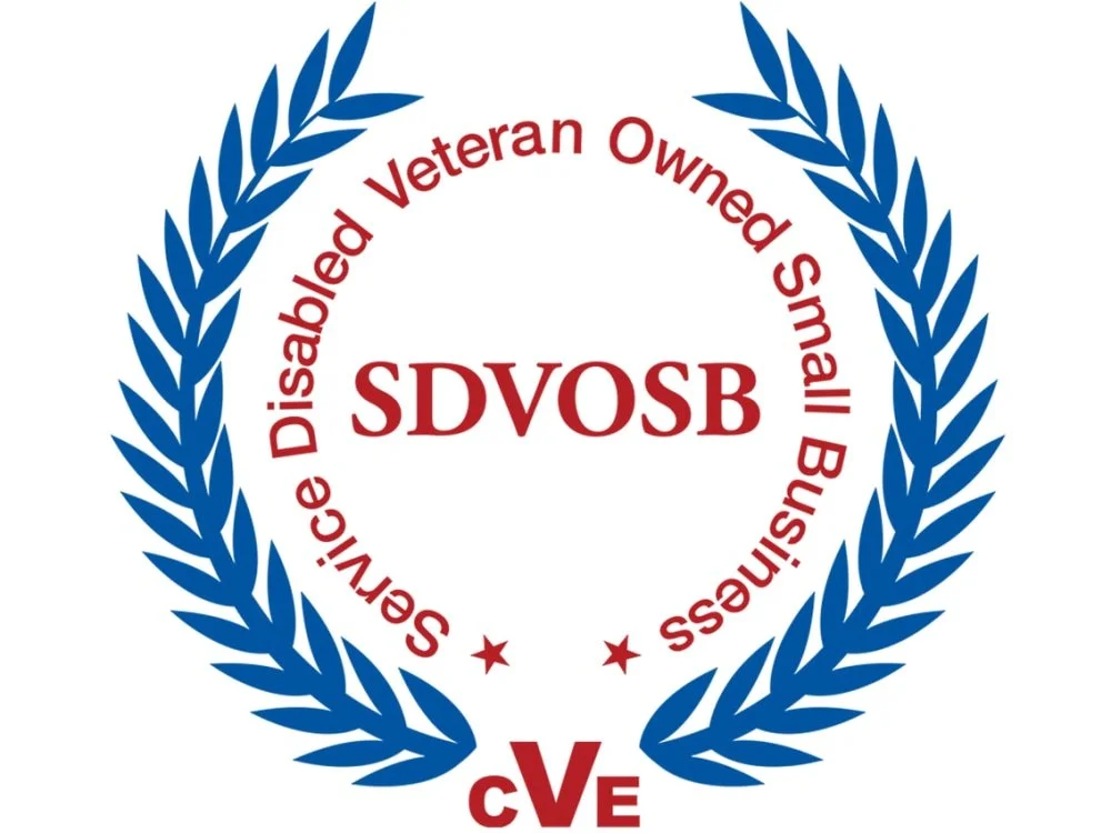 A circular emblem with blue laurel branches. Inside, red text reads "Disability Veteran Owned Small Business." The acronym "SDVOSB" is in the center in bold red letters. The bottom of the emblem has the acronym "CVE" in red.