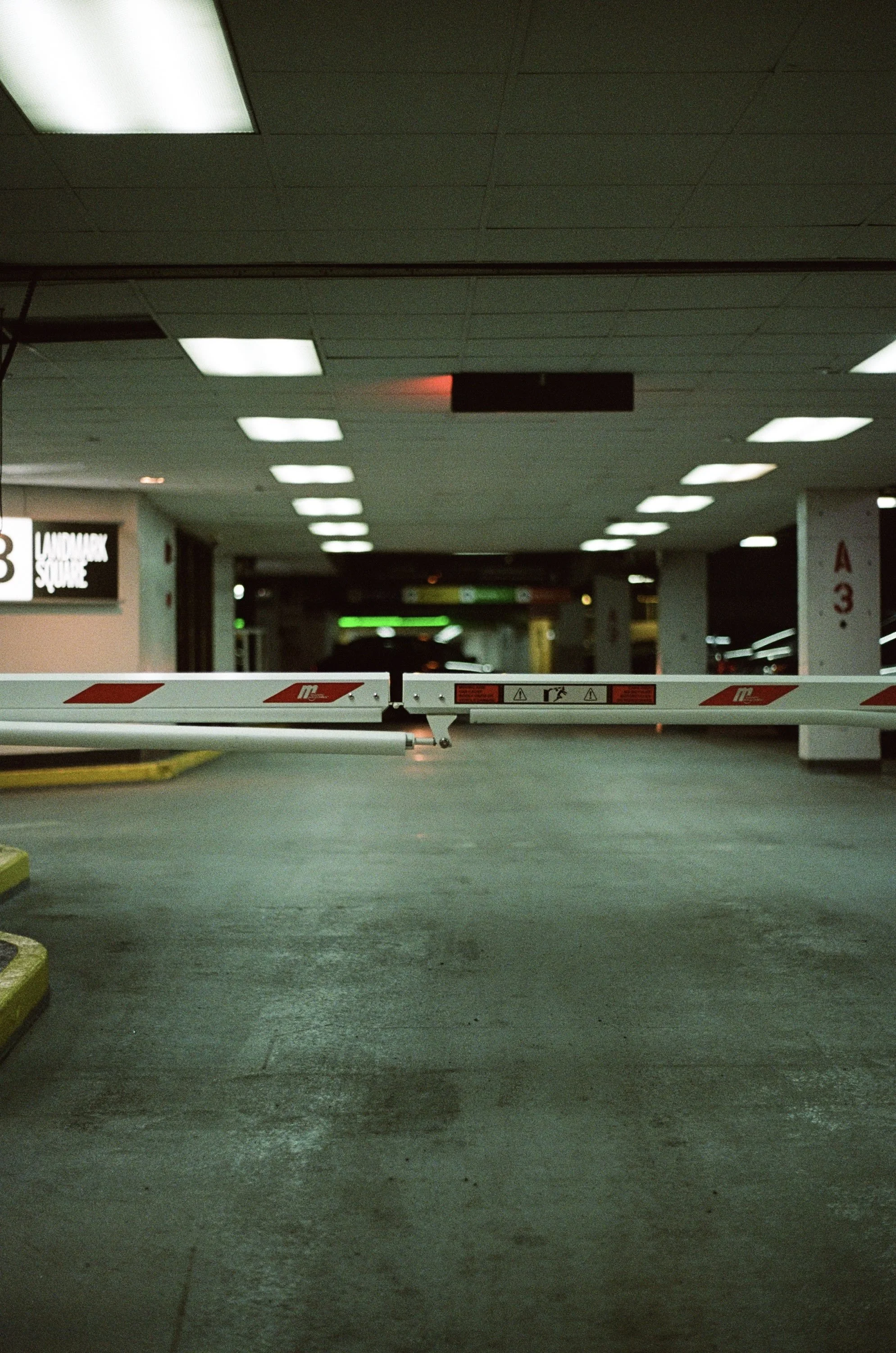 Empty parking garage with a closed barrier gate blocking entrance.