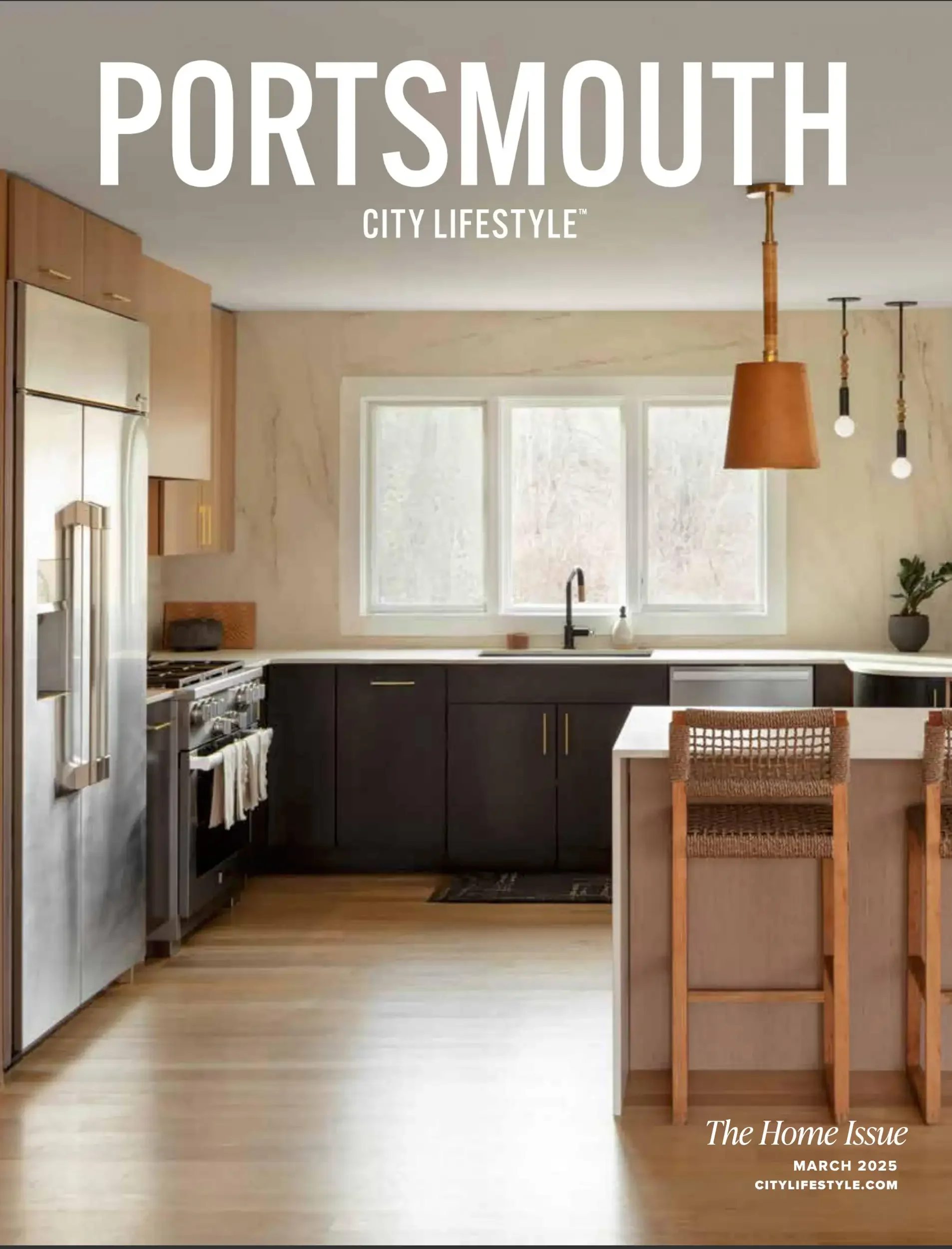 Cover of a magazine titled 'The Home Issue' from March 2025, featuring a modern kitchen with wooden cabinets, a window above the sink, black lower cabinets, a kitchen island with a wooden barstool, pendant lighting, and hardwood flooring.