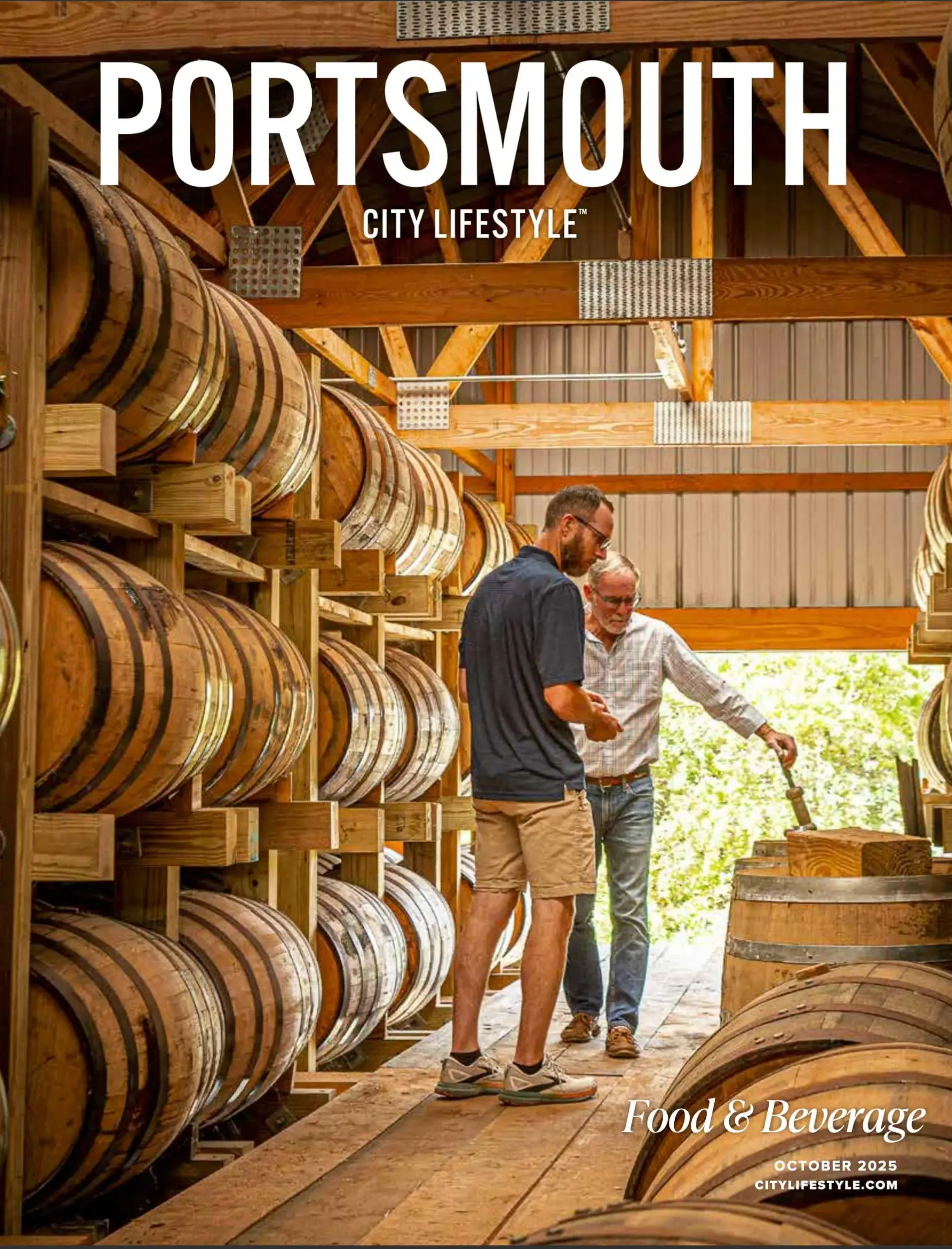 Cover of a magazine titled 'Portsmouth City Lifestyle' featuring a group of people standing among barrels in a brewery or distillery with a focus on food and beverage, dated October 2025.