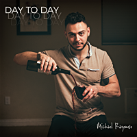 Man pouring wine into a glass in a dimly lit room with a photo frame on the wall