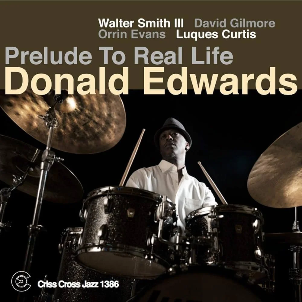 Album cover featuring a jazz drummer playing drums, with the album title 'Prelude To Real Life' and the artist name 'Donald Edwards' displayed at the top.