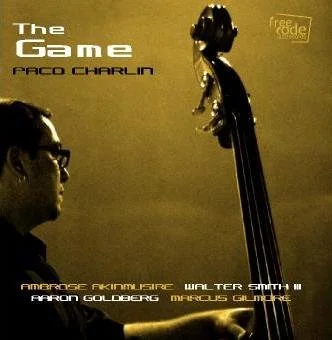 Book cover titled 'The Game' by Paco Charlin with a man playing a double bass on a yellow background.