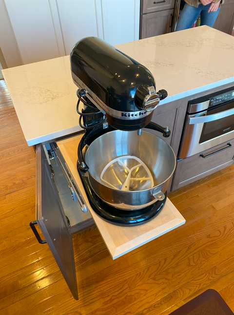 KitchenAid stand mixer with mixing bowl and attachments on a kitchen countertop