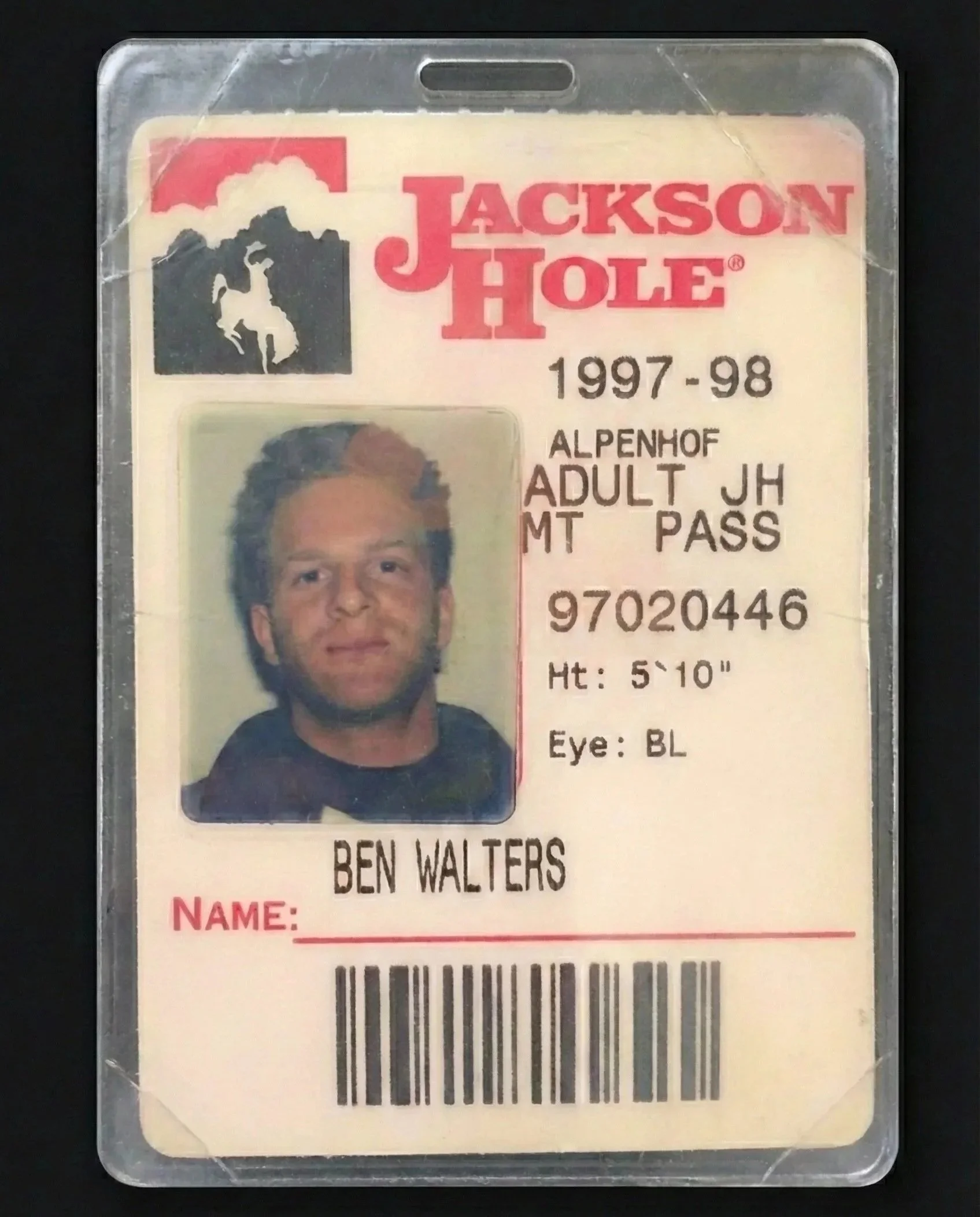 A vintage Jackson Hole ski pass card from 1997-98 featuring a photo of a man with light-colored hair and a beard, with details including name 'Ben Walters', height 5'10'', eye color blue, and an Alpenhof adult pass.