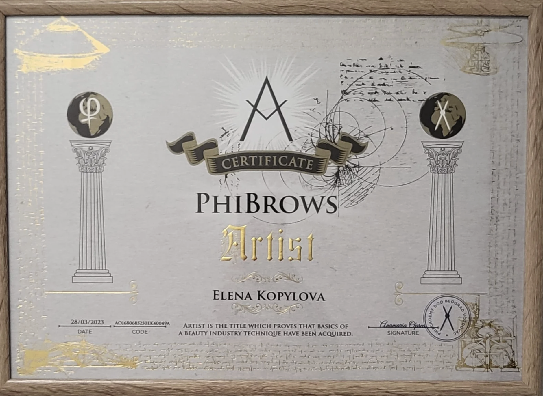 A certification award for an artist named Elena Kopylova from PhiBrows, with decorative columns, globes, and abstract designs on a framed silver background.