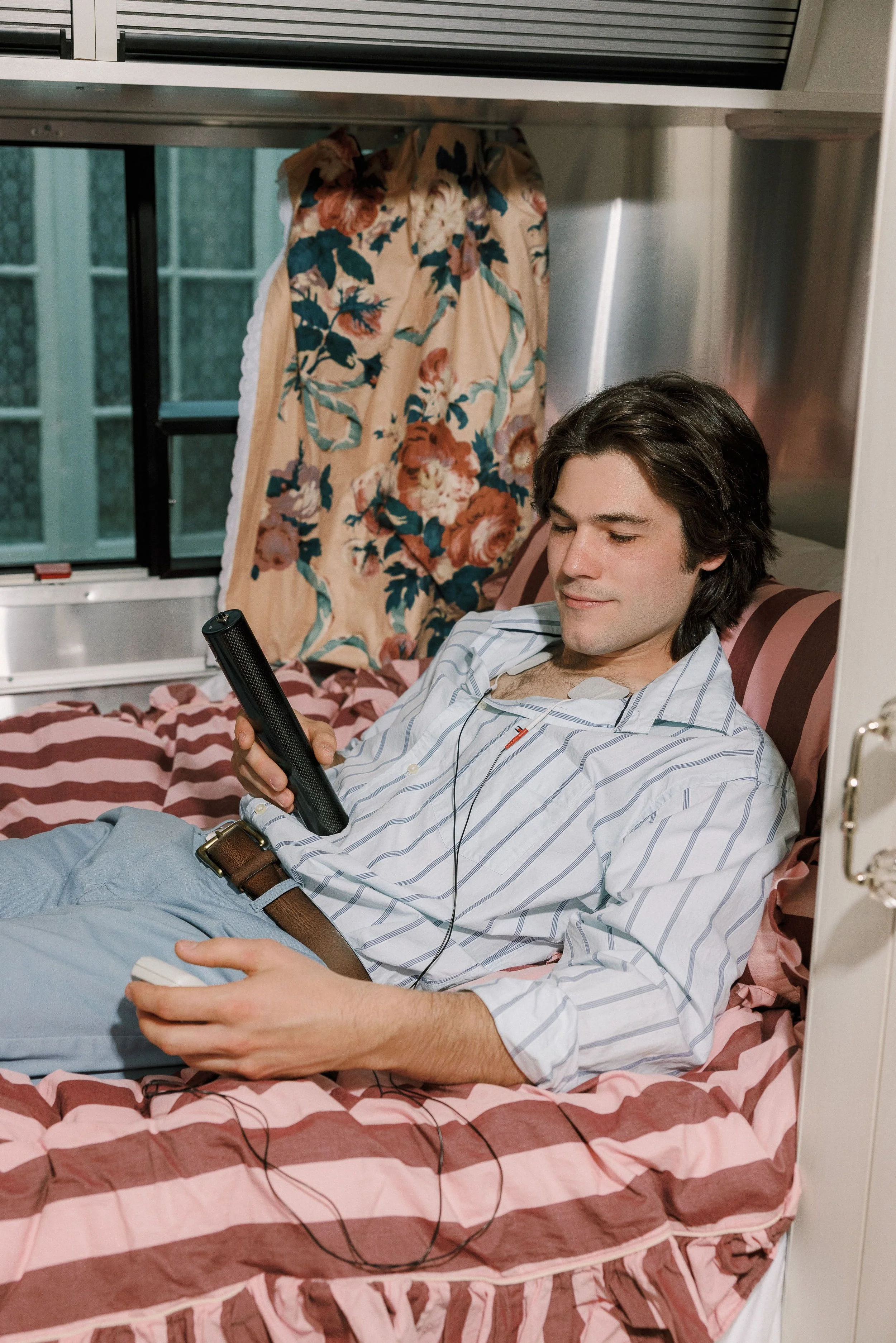 A young man is getting treatment in the Floral Botanical Medicine Airstream