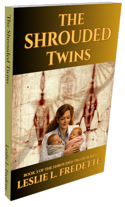 Book cover titled "The Shrouded Twins" by Leslie L. Fredette, featuring Dr. Nicole McHenry holding two sleeping twins, set against a background with the Shroud of Turin and DNA.