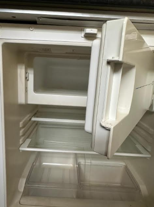 An open empty white refrigerator with two shelves and a small freezer compartment at the top.