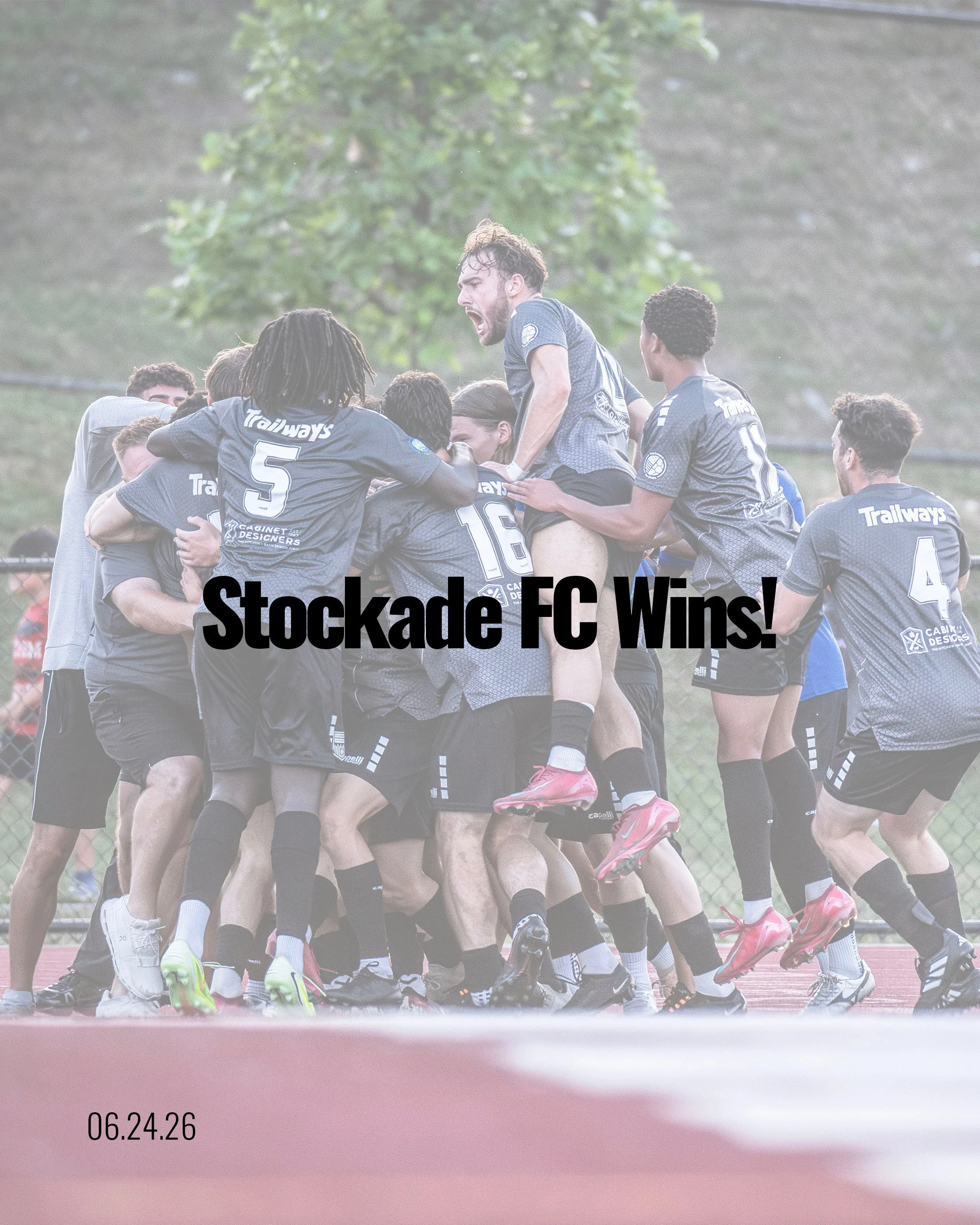 A group of rugby players celebrating together on a field, some are hugging or holding each other. They are wearing blue jerseys with sponsor logos, and the background shows a green outdoor setting with trees. The image has a caption that says "Stockdale FC Wins!" and a timestamp of "06.24.26".