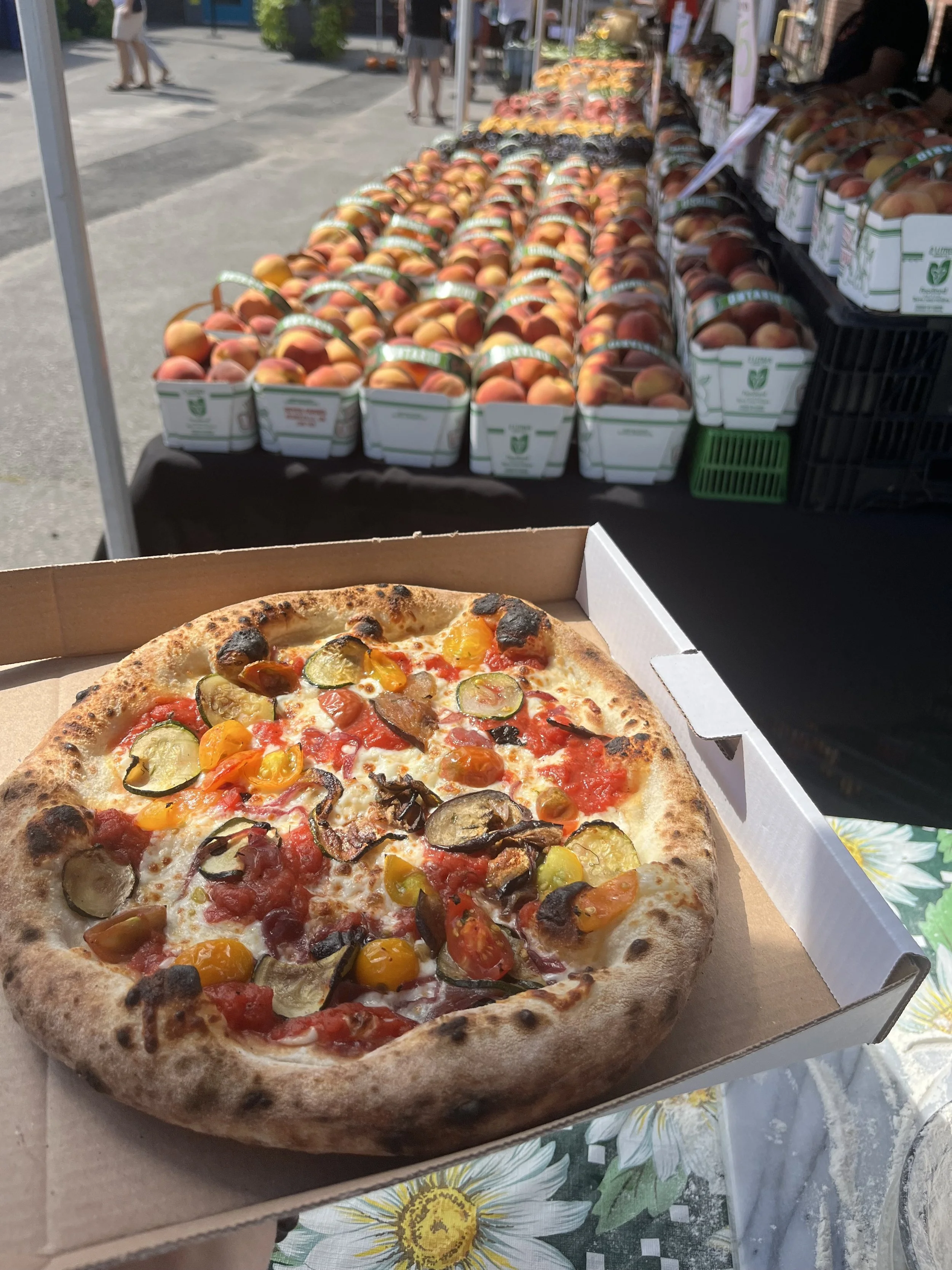 Vegetarian pizza with roasted zucchini, eggplant, marinated heirloom cherry tomatoes at the Lakeview Farmers Market, 2025