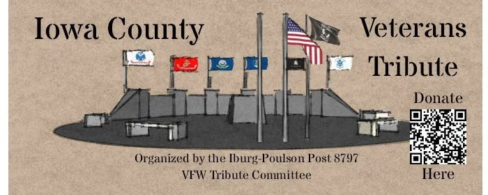 Sign for Iowa County Veterans Tribute with American flags on a monument, a QR code, and text indicating donation options, organized by the Iburg-Poulson Post 8797 VFW Tribute Committee.