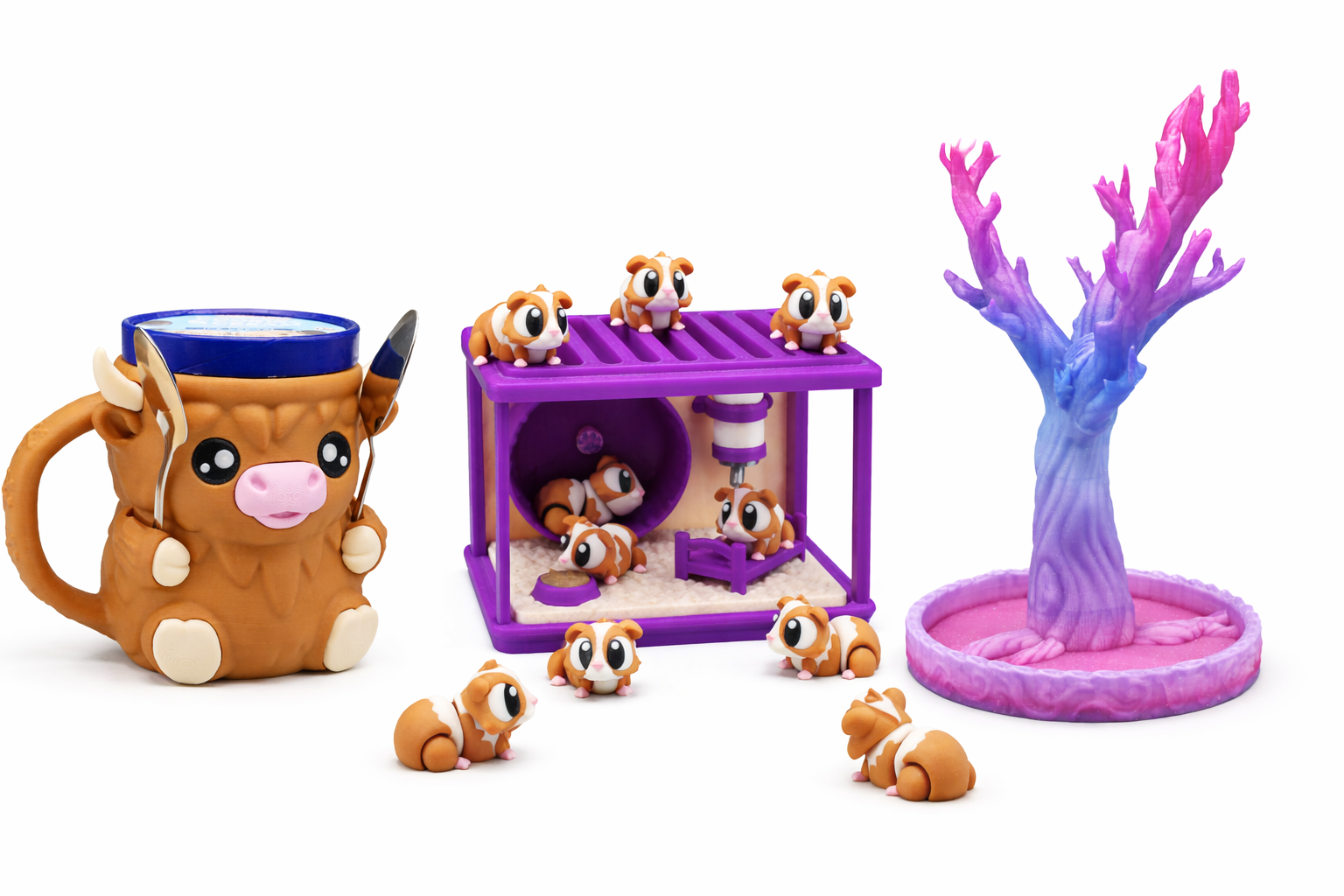 Toy hamster set with an orange hamster mug, small hamster figures, a purple hamster cage with hamsters inside and outside, and a pink and purple plastic tree