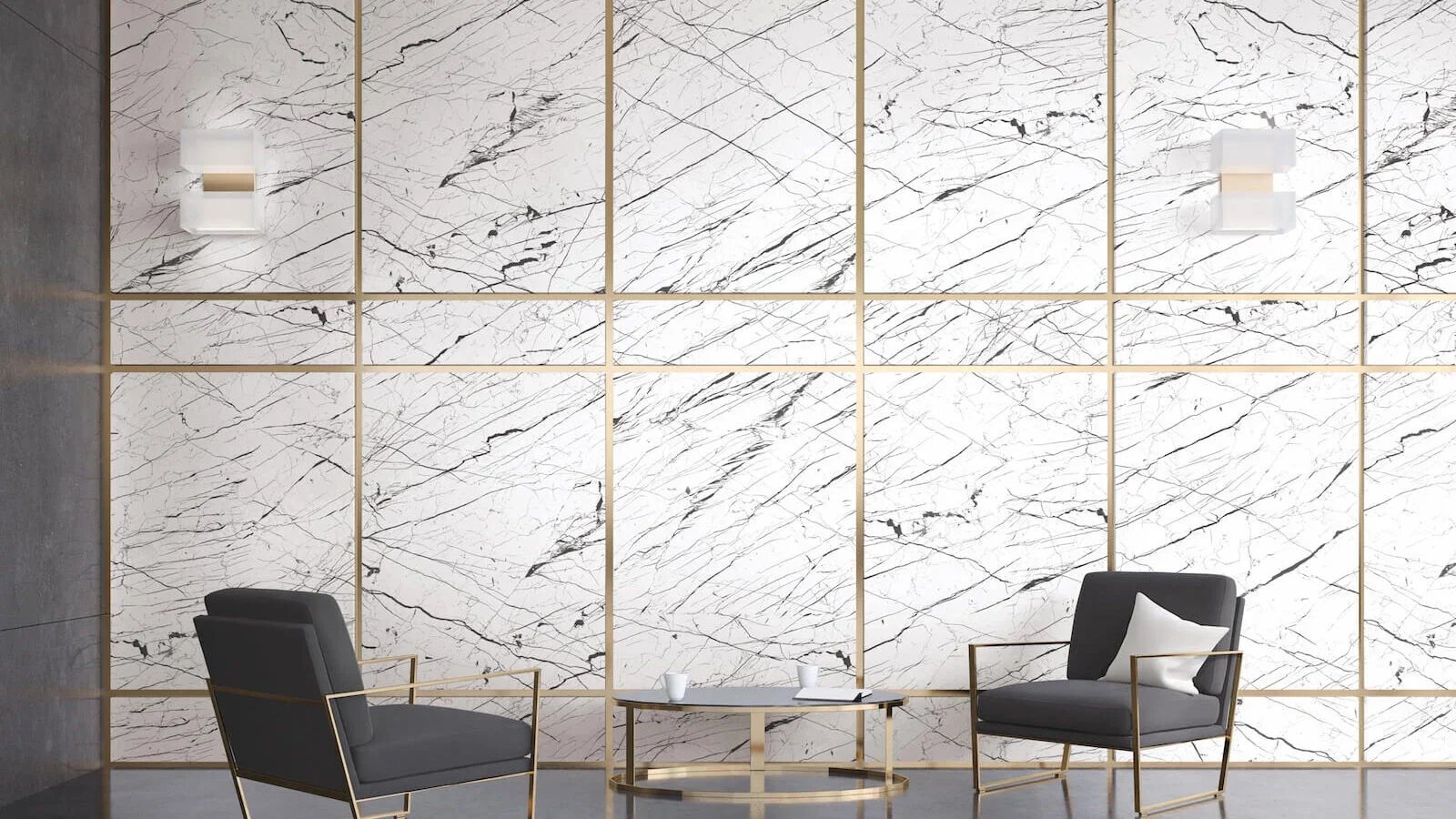 Modern seating area with two black armchairs with gold frames, a round coffee table with a gold base, and white cups on the table, set against a large white marble wall with black veins.