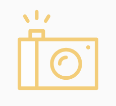 An orange graphic logo of a camera with a flash.