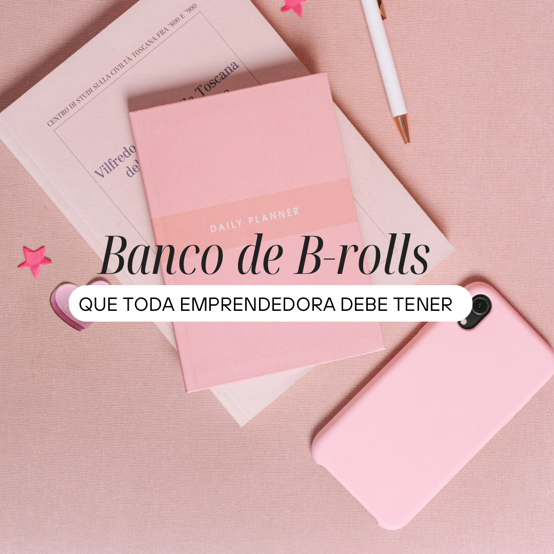 Cuaderno rosa, una agenda diaria, un teléfono móvil rosa, y un bolígrafo en un fondo de tela rosa, decoraciones en forma de estrellas y corazón