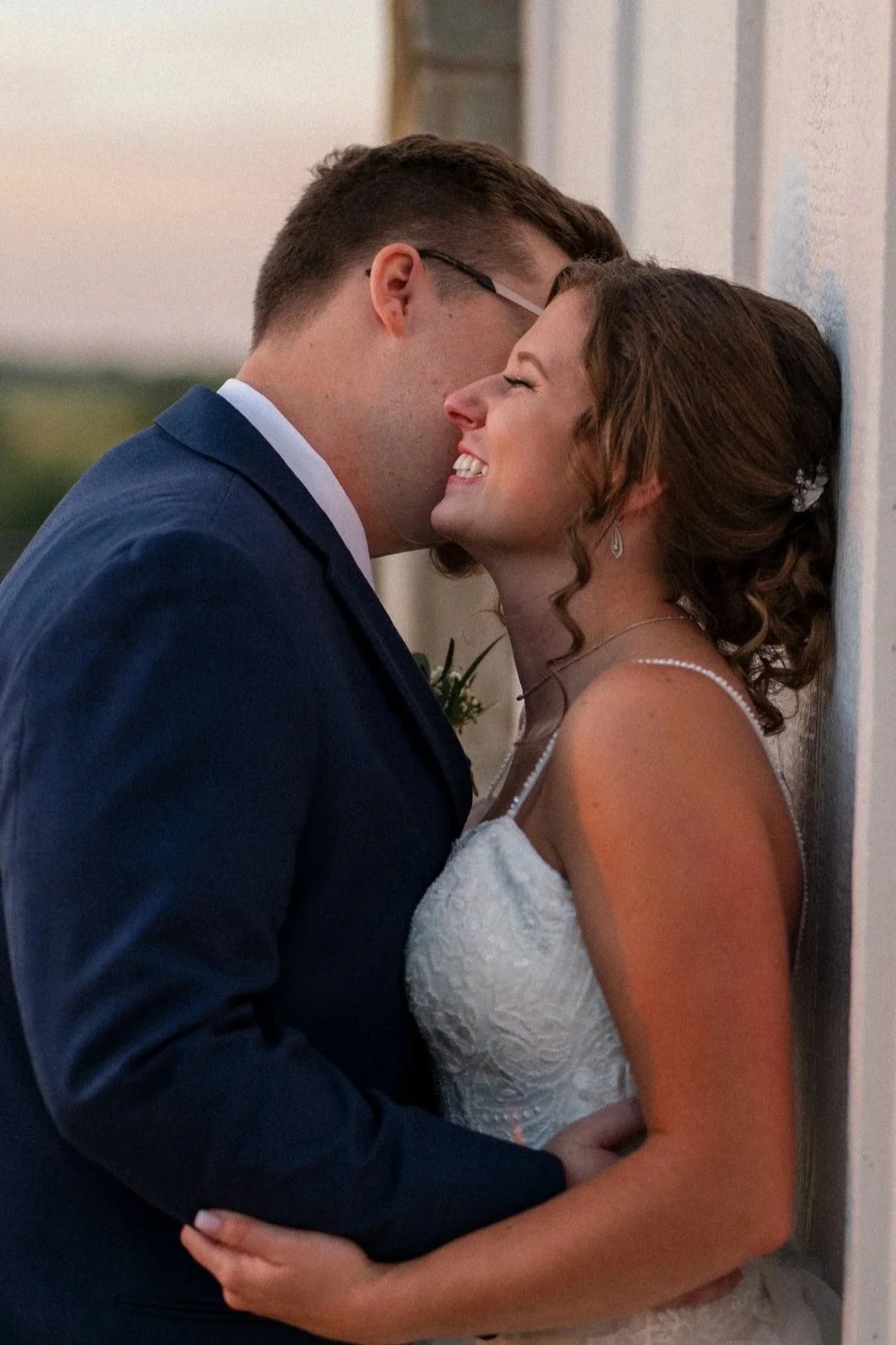A Dallas groom and bride share an intimate moment, with their foreheads touching and eyes closed, during a wedding.