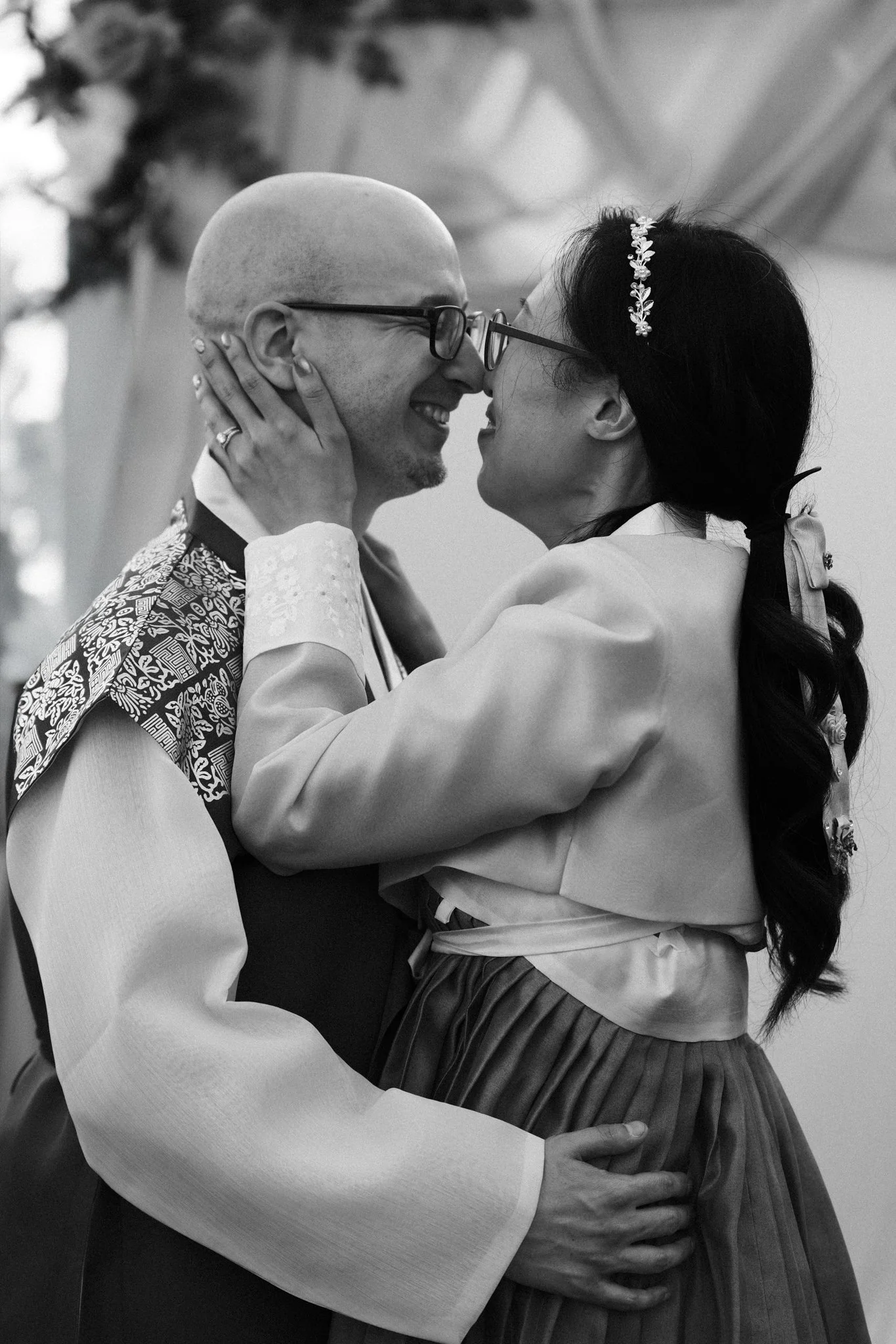 A black-and-white photograph of a Dallas newlywed couple dancing closely, smiling, with their foreheads touching and arms around each other.