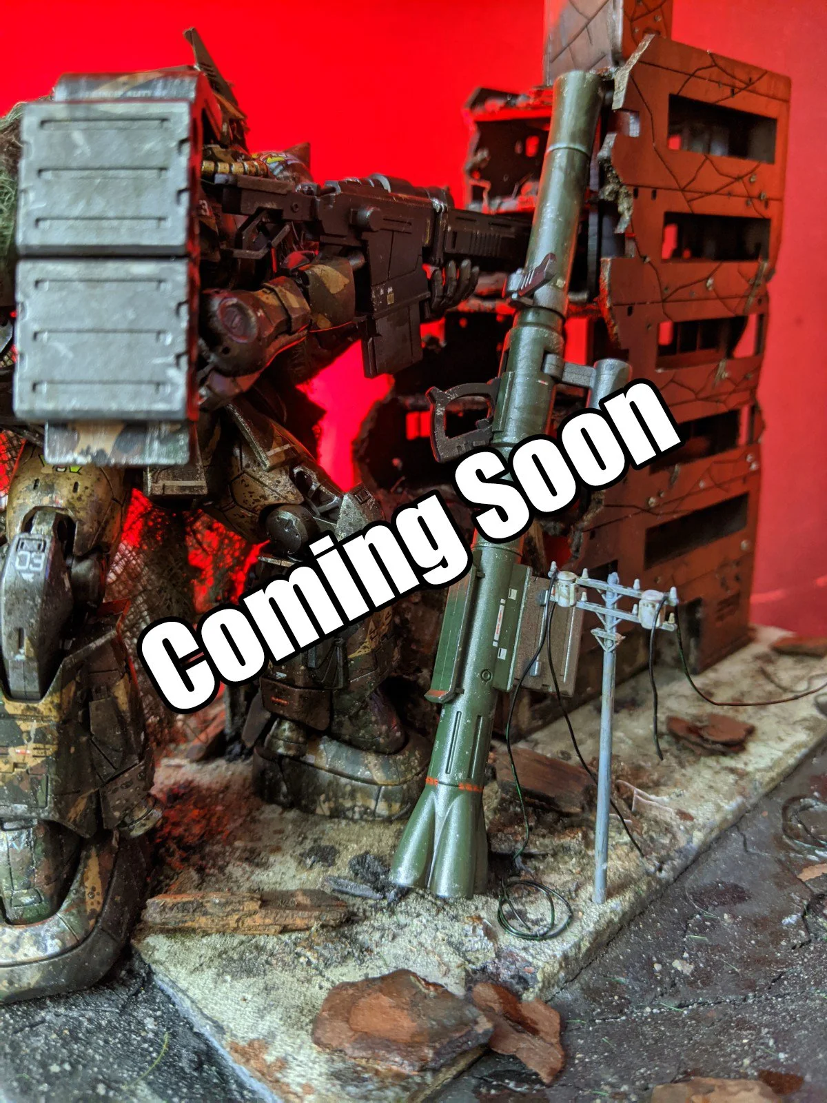 Model of a military robot with a large gun, damaged and weathered, in a war-torn setting with debris and destroyed structures behind it.