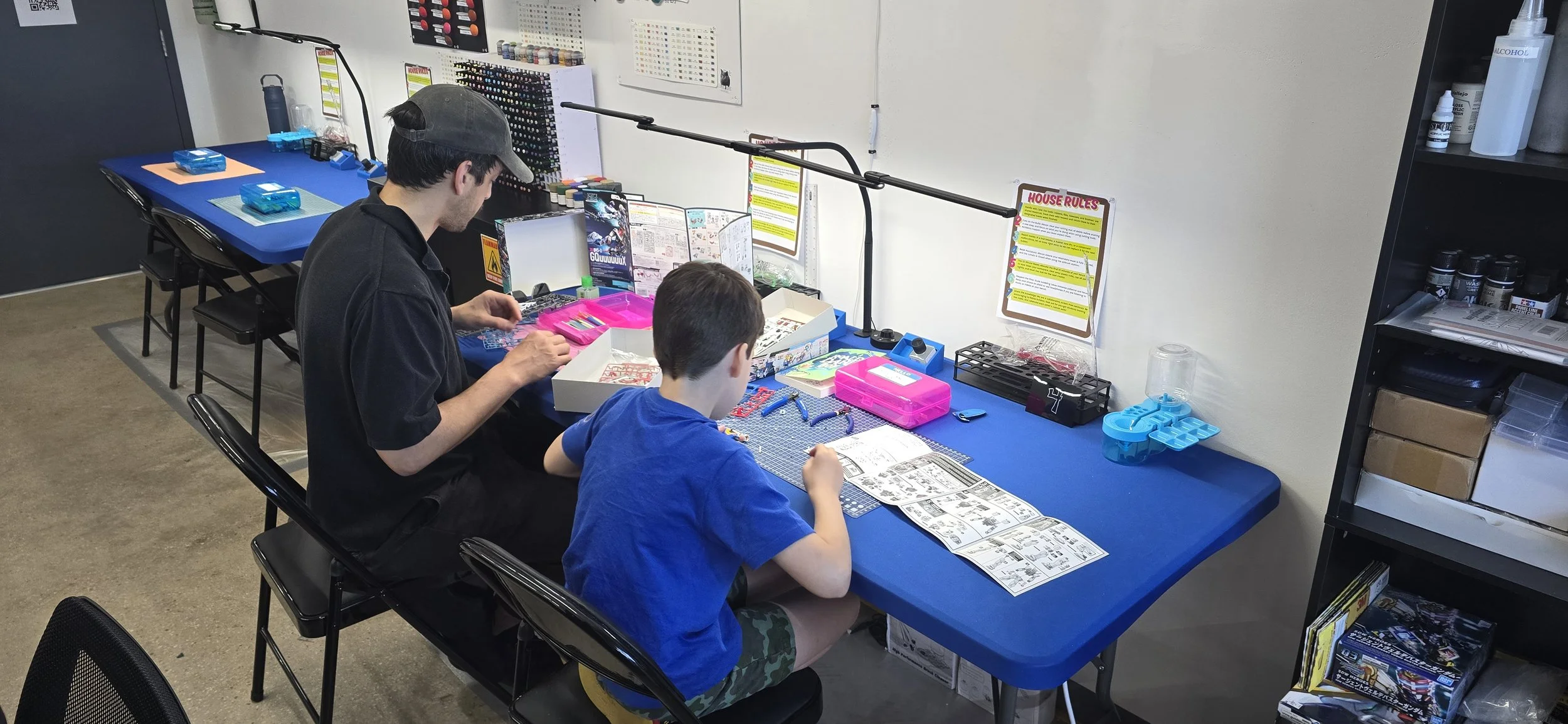Father and son building Gundam models
