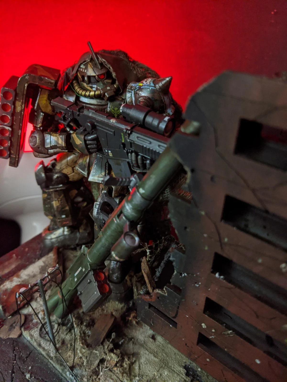 A highly detailed collectible action figure of a futuristic robot soldier aiming a large gun, with a red background.
