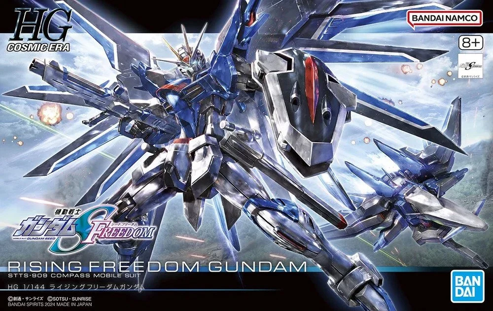 Box art for the Rising Freedom Gundam model kit, featuring a large, blue, robotic Gundam with wings, weapons, and a horse-like head, set against a cloudy sky, with logo and branding for Bandai and Gundam.