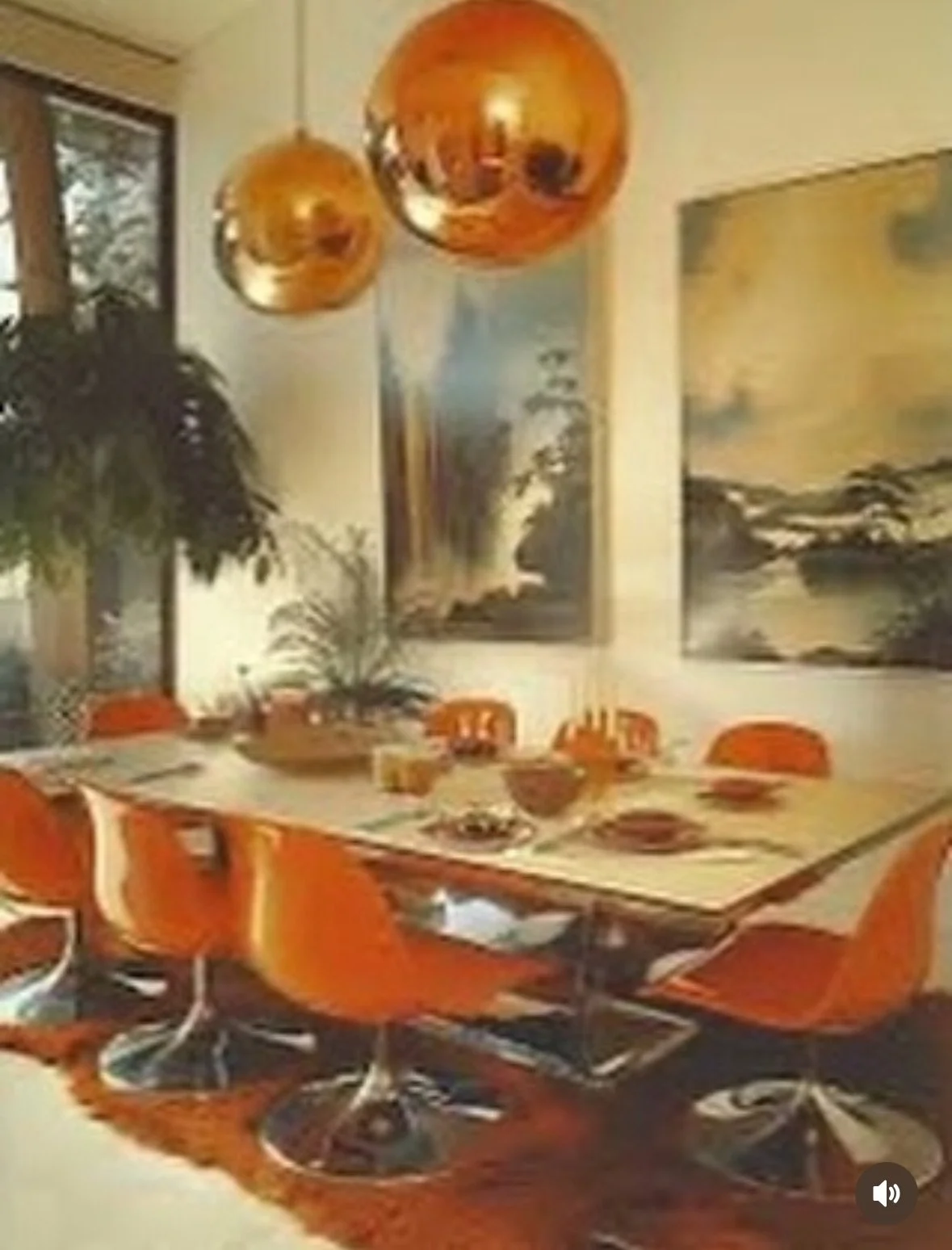 A dining room with a wooden table, eight orange chairs, and decorative art, two hanging orange spherical pendant lights, and large screens on the wall.